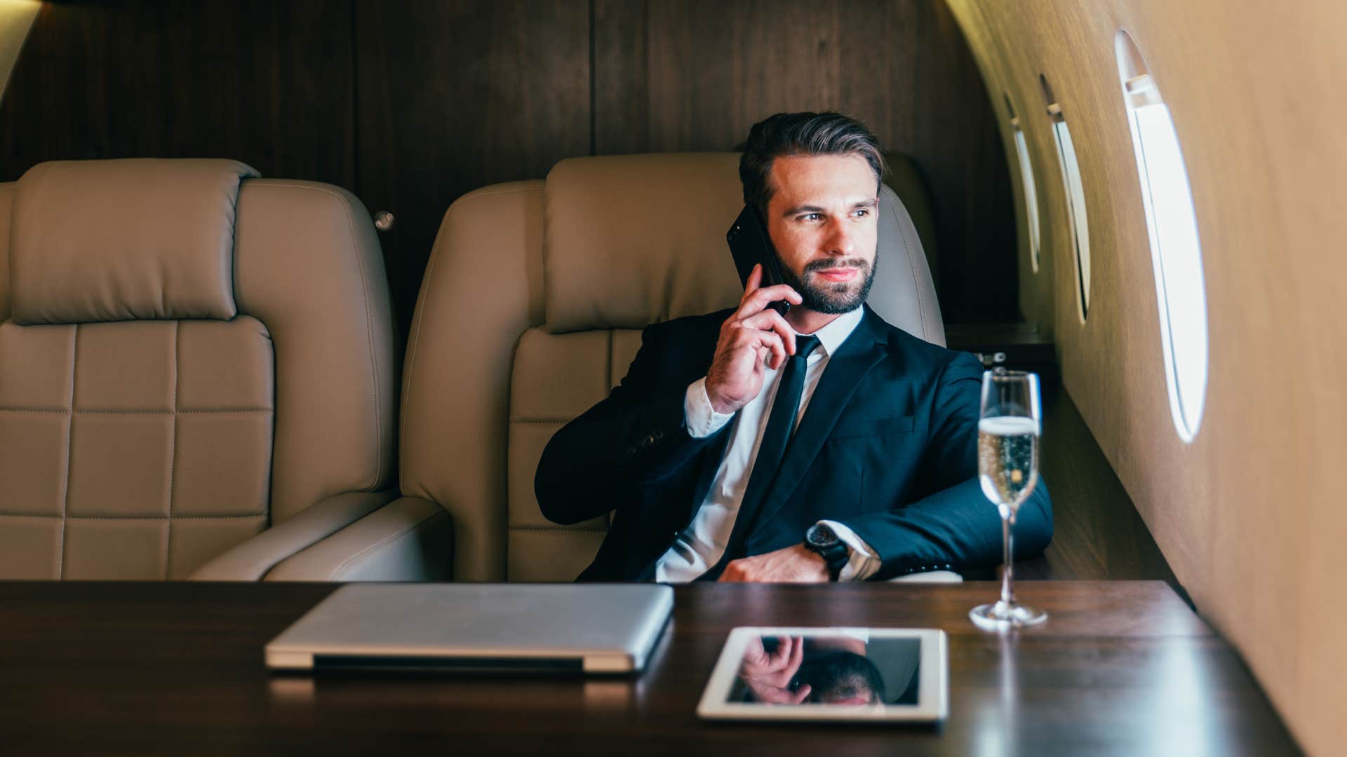 wealthy man flying on a private jet