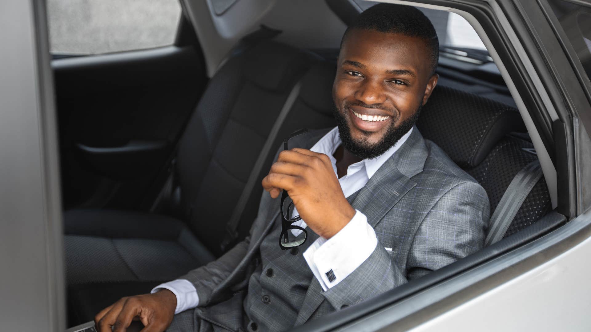 wealthy man sitting in limo with flexible schedule