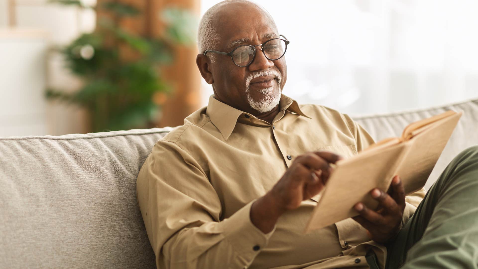 man smiling and reading a book he actually enjoys