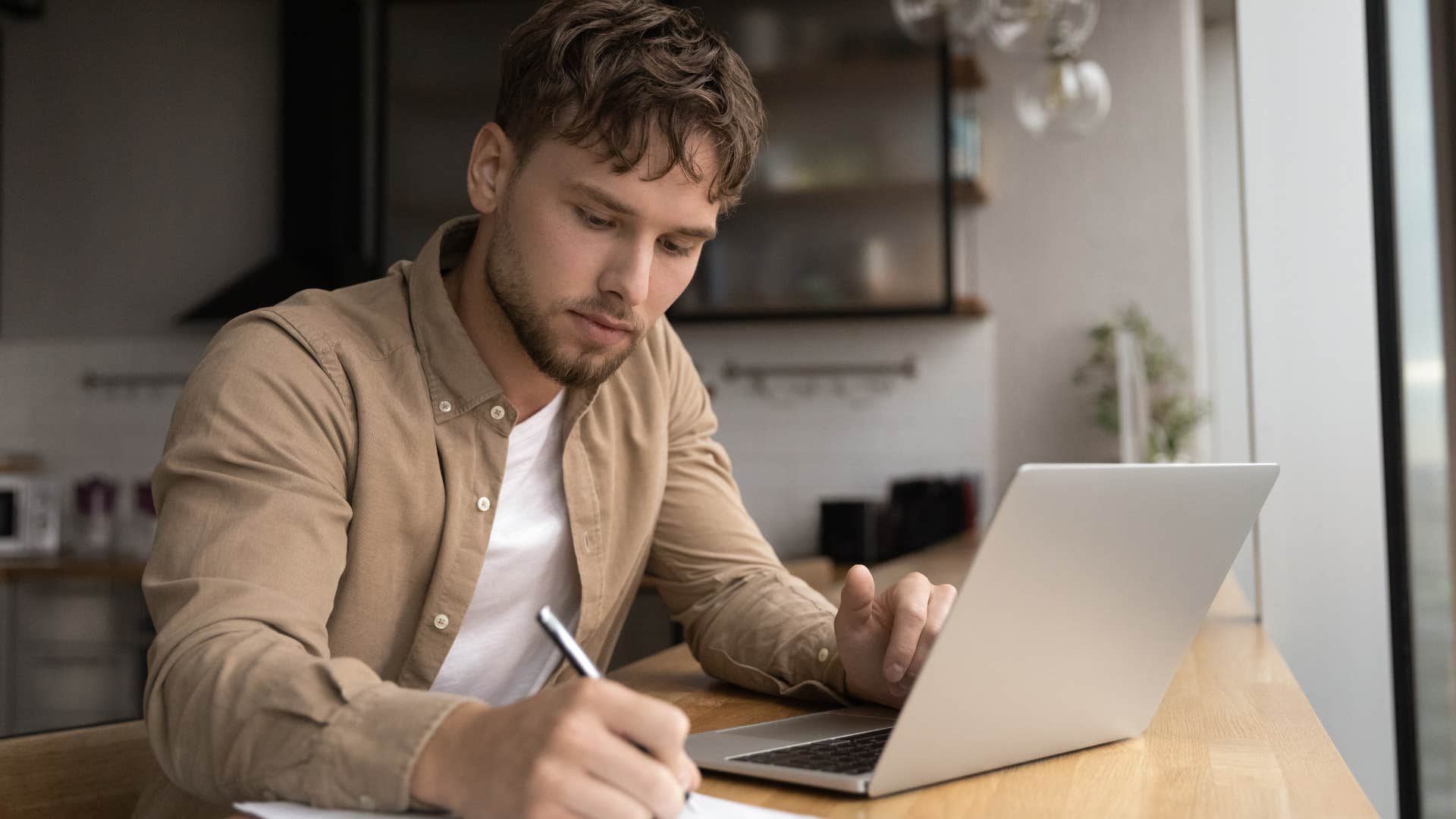 man writing to-do lists in his home