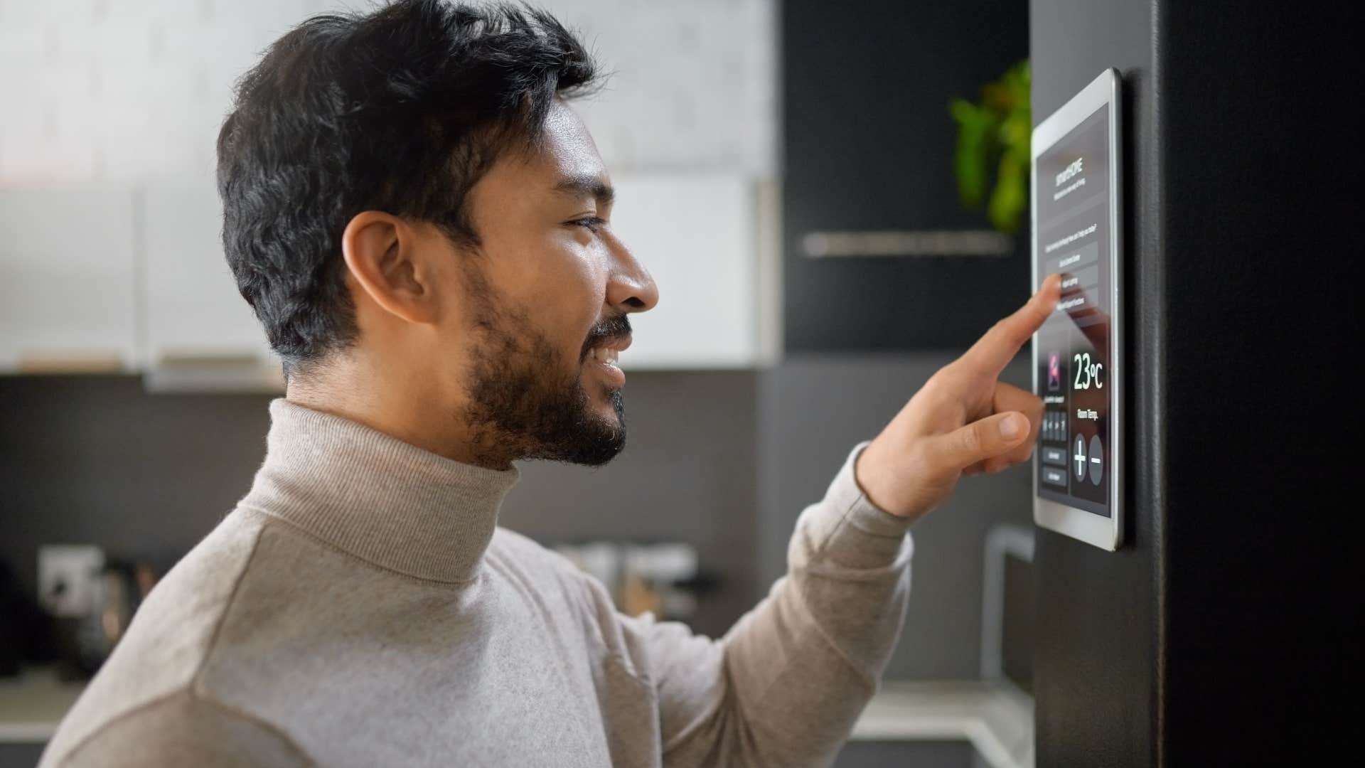 man setting up cameras in his home on a tablet