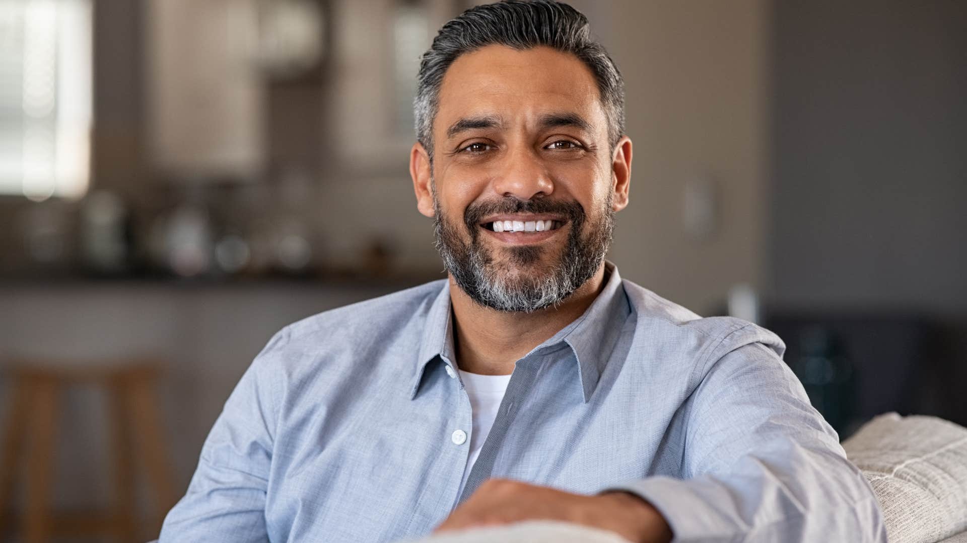 classy man who doesn't care about fitting in smiling