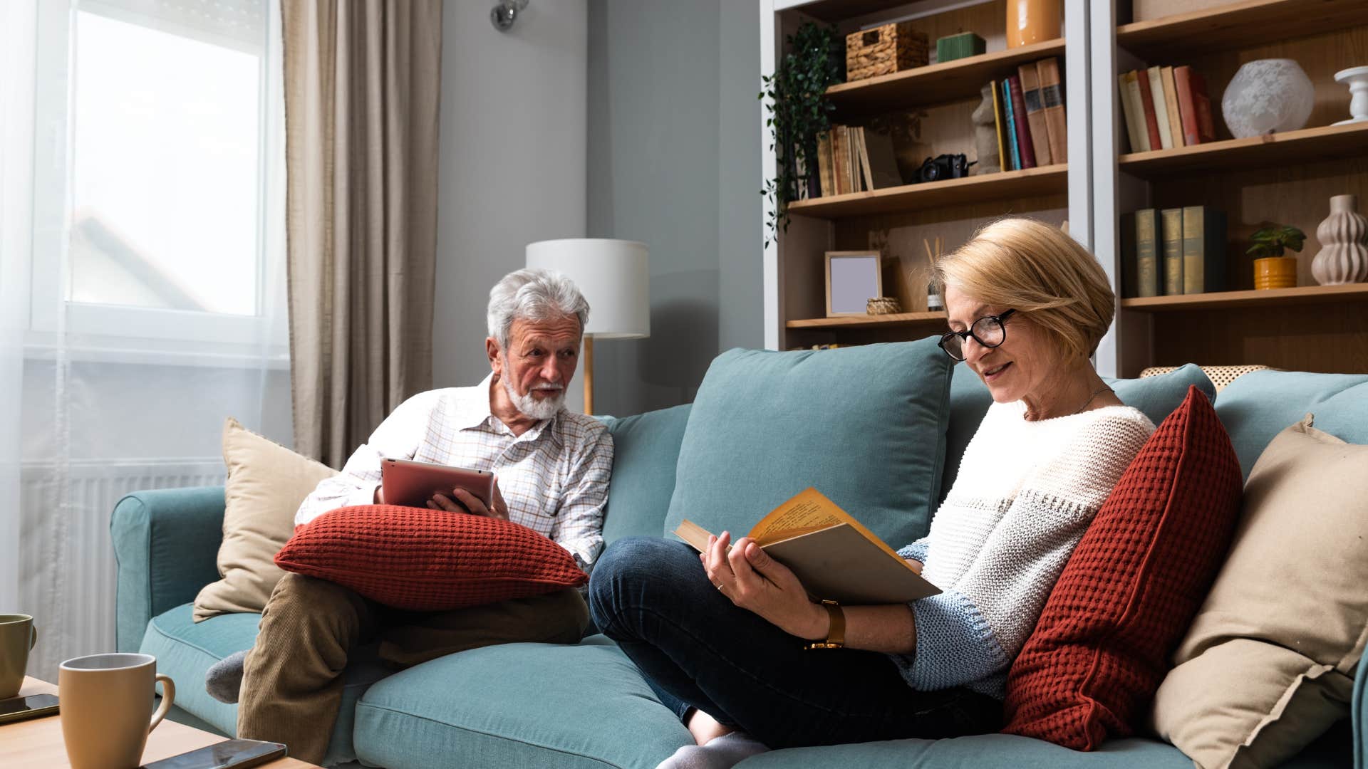 couple reading books in their home library