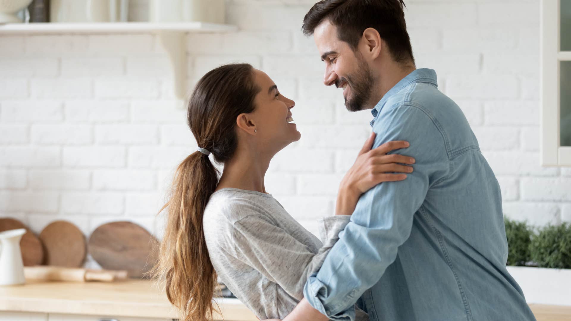 couple intimately hugging and laughing with each other