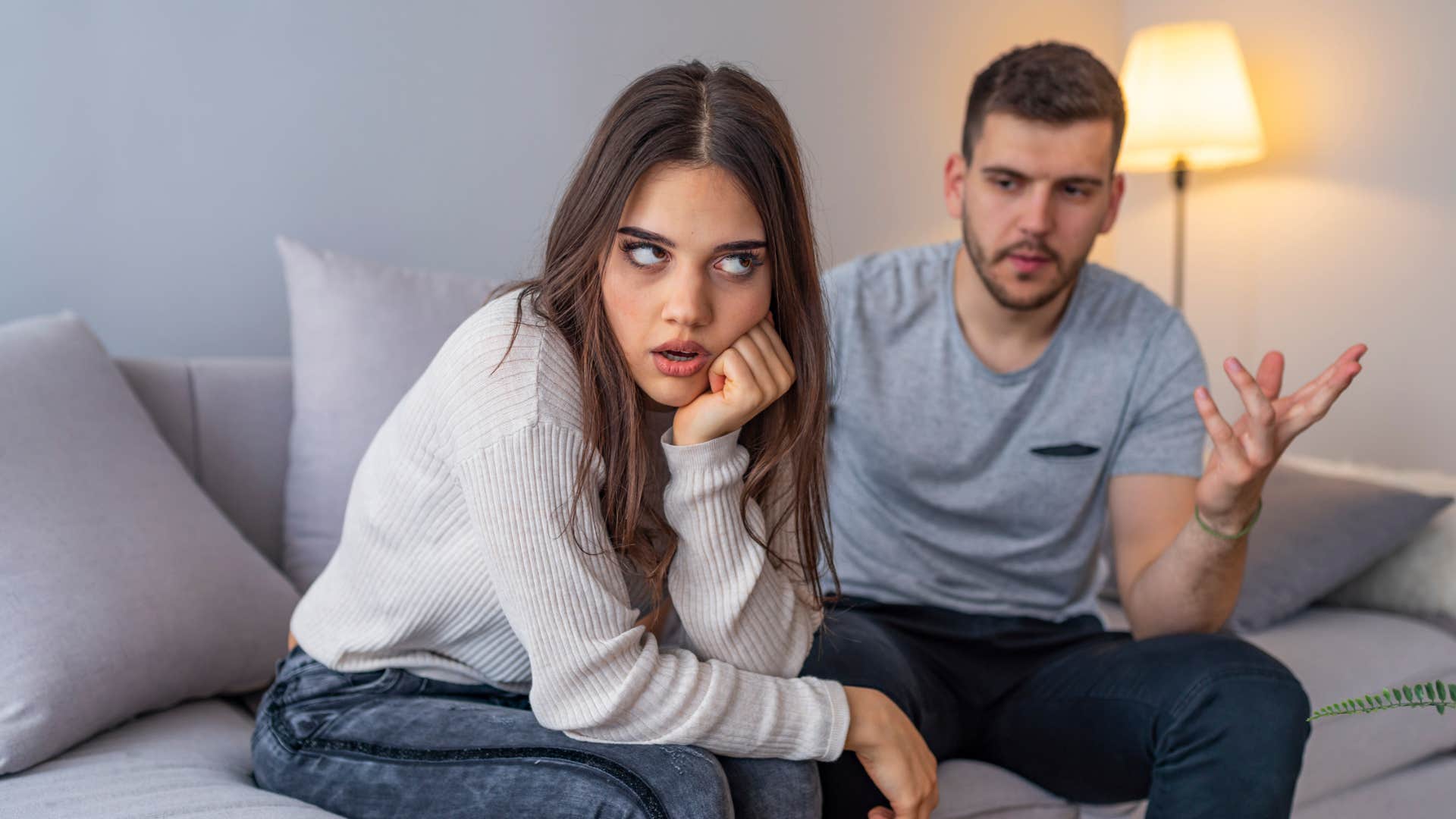 woman turned away from partner annoyed rolling her eyes