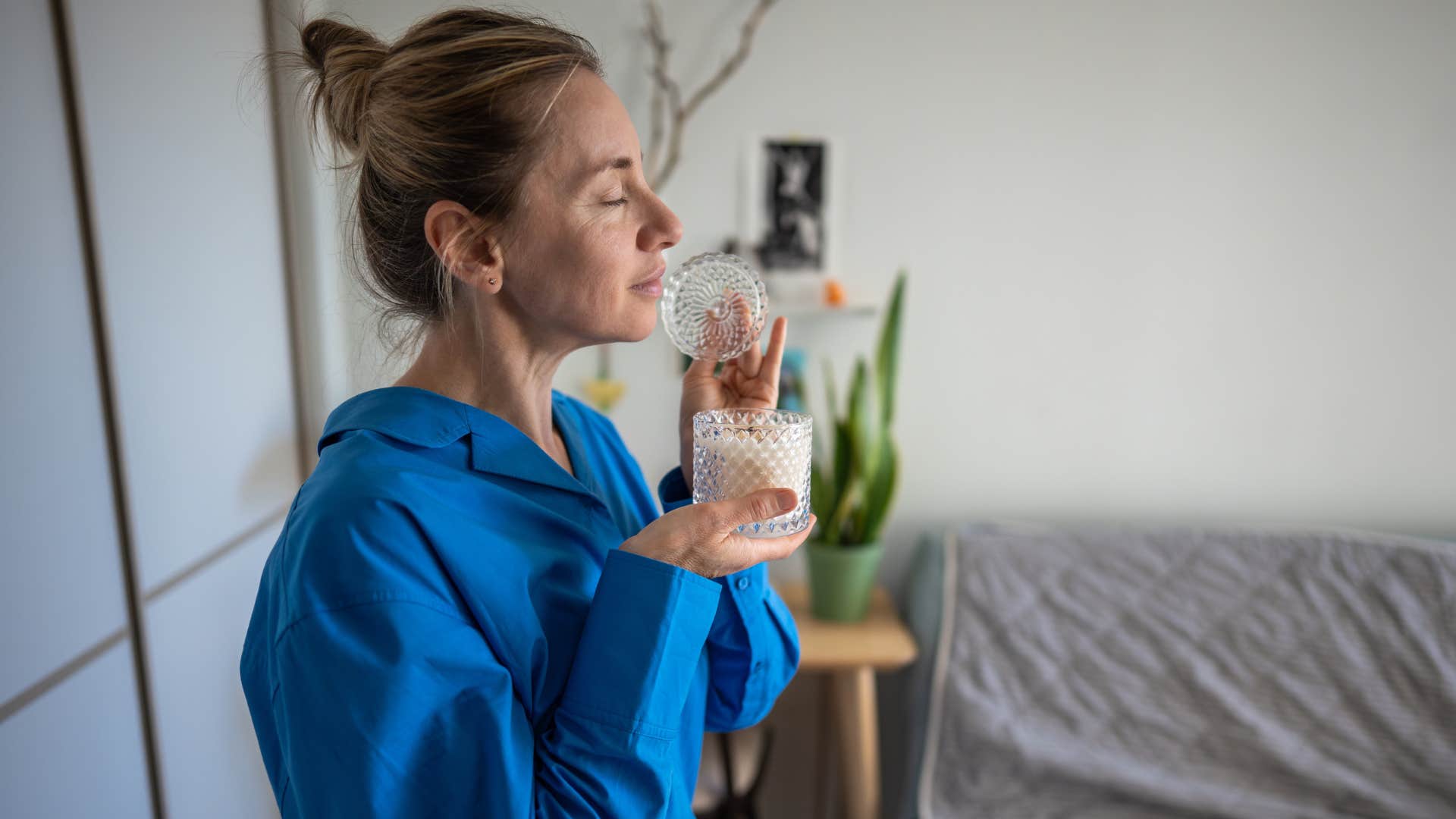 a wife places personal touches to her home like a small candle
