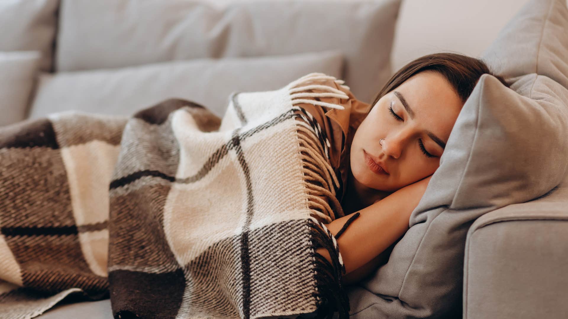 Woman sleeping on the perfect couch for a nap.