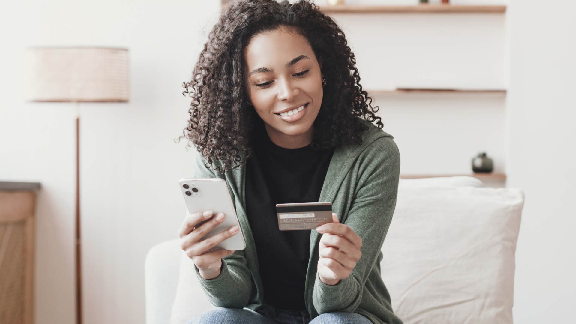 Happy woman saying "it's an investment" while buying something online.