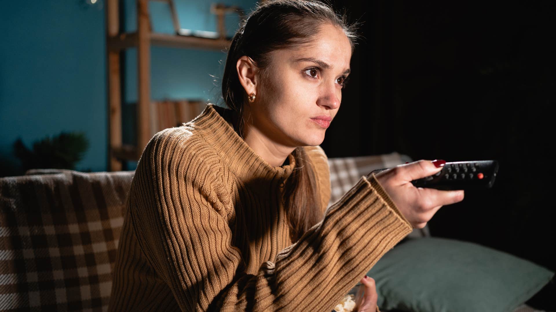 woman scrolling through subscriptions on her TV