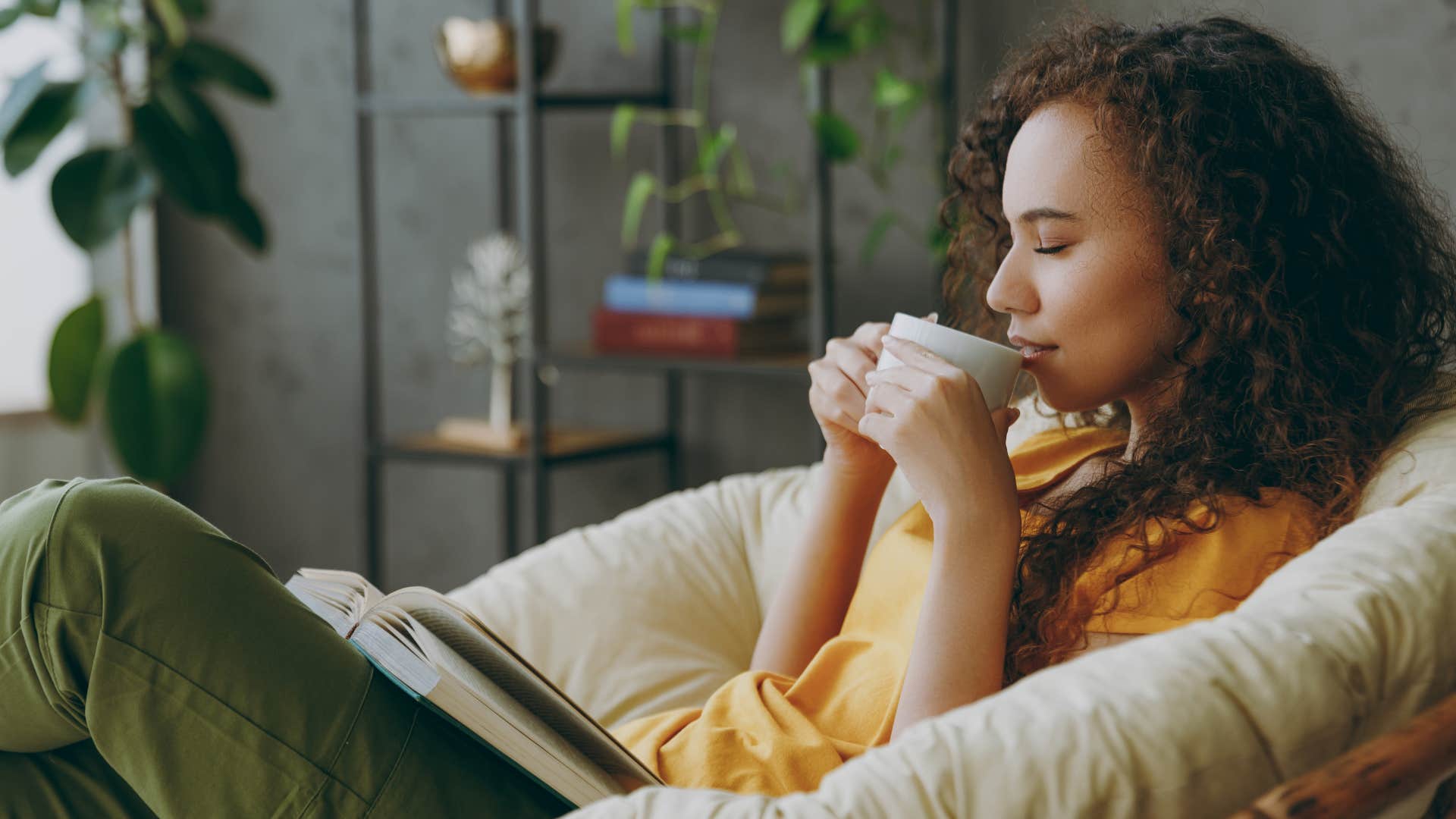 woman drinking coffee while sitting on new furniture