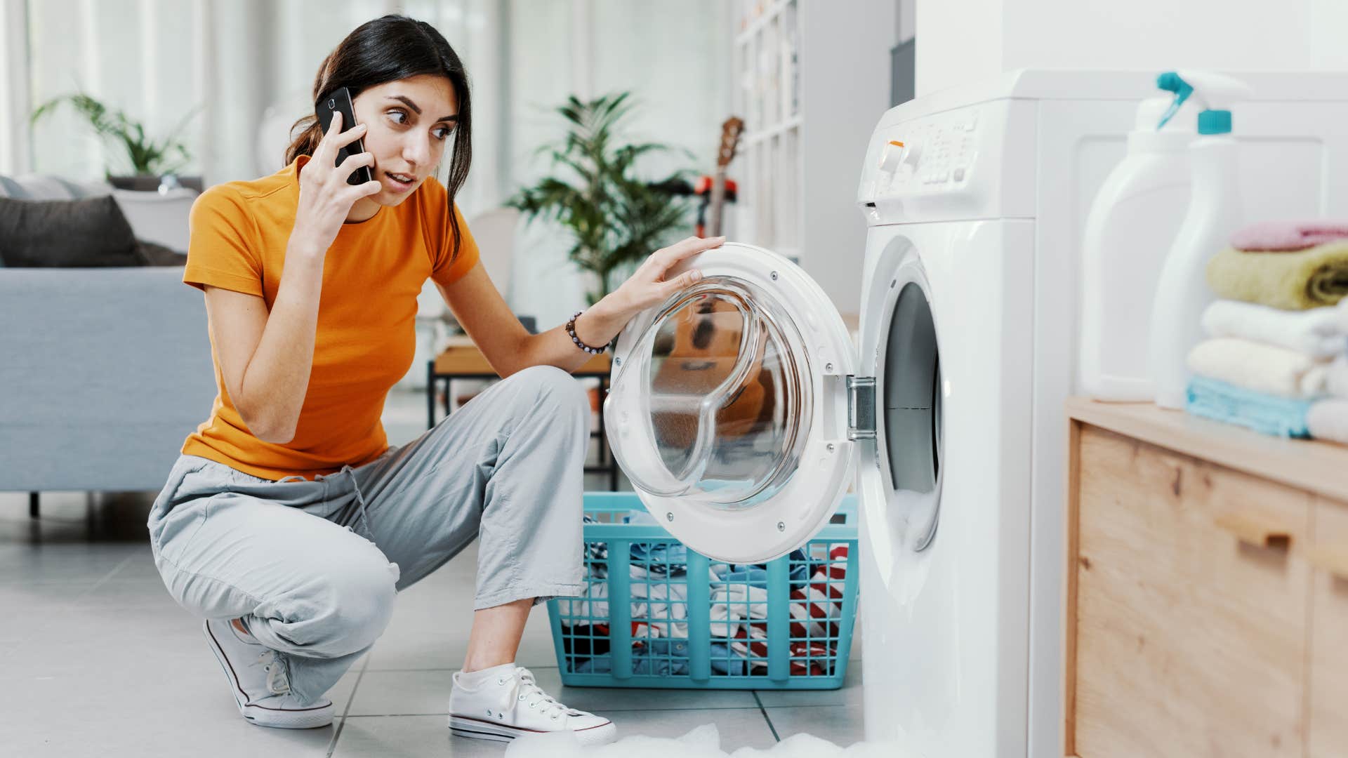 woman on phone to fix broken washing machine