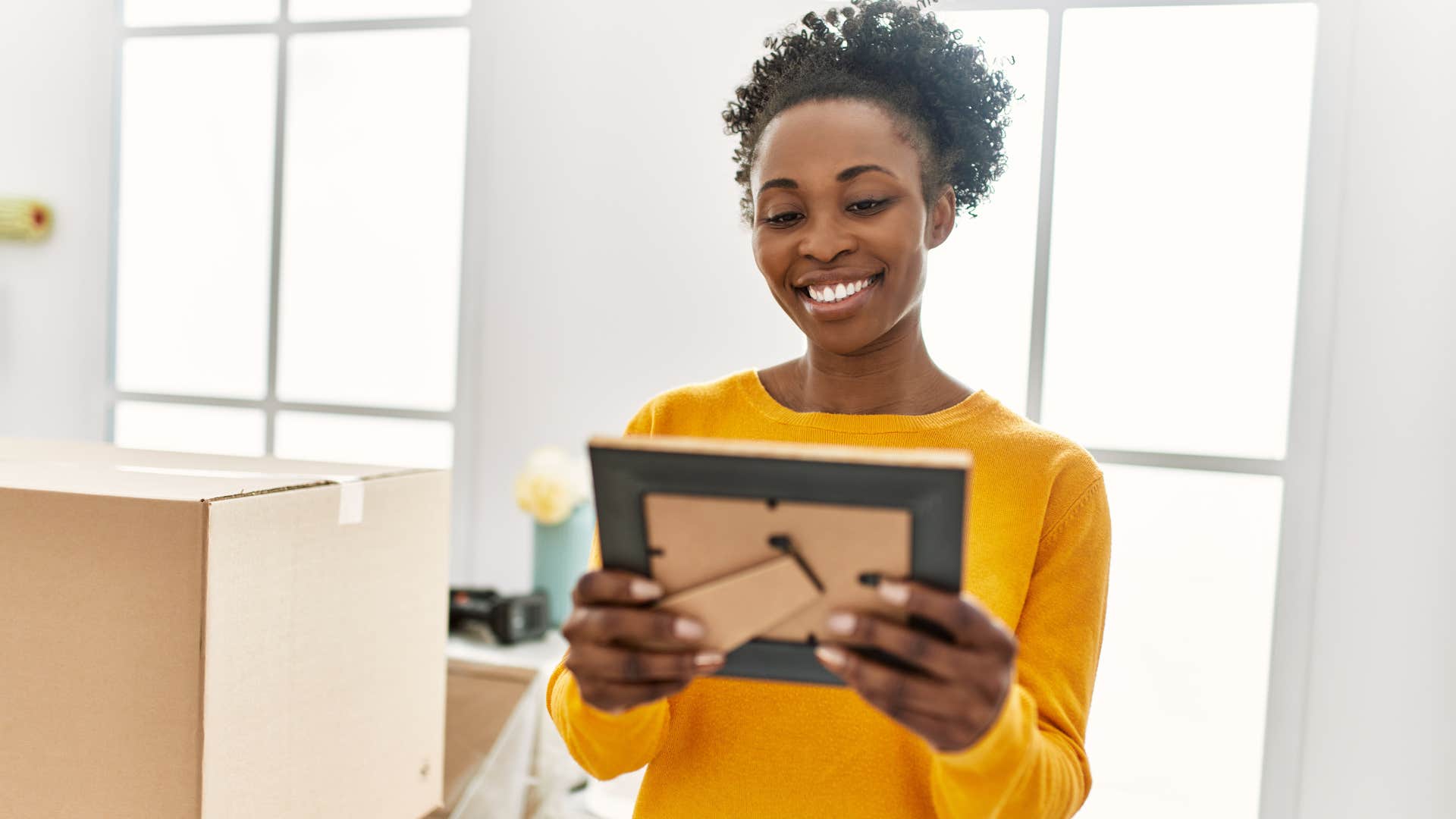 woman looking at sentimental items from lots of boxes