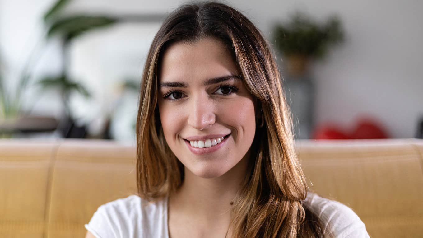smart woman sitting in her living room smiling