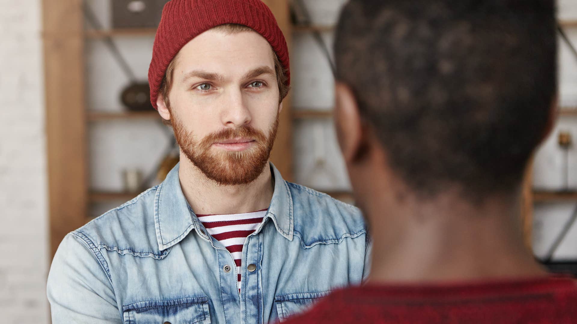 serious man who knows brutal honesty is just cruelty in disguise talking to a friend