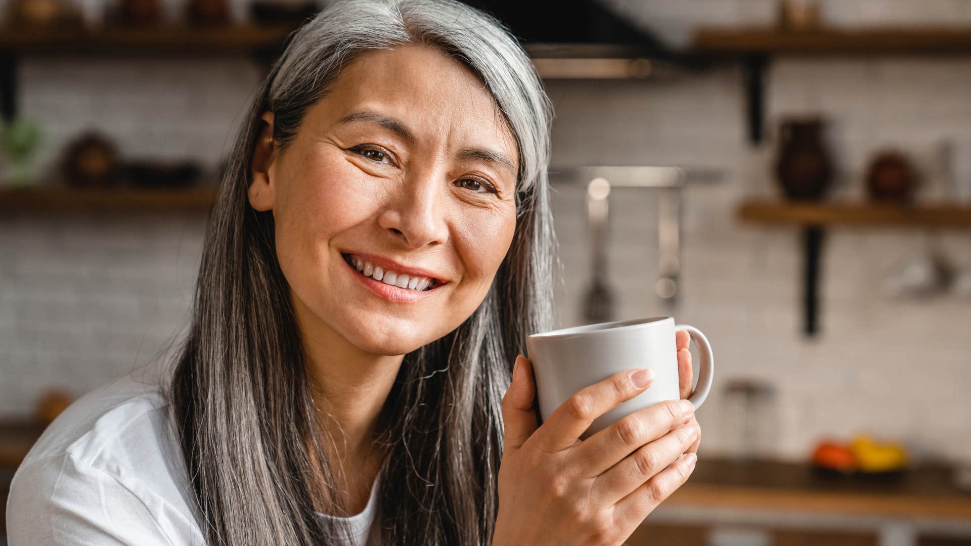 woman with integrity smiling with a cup of coffee