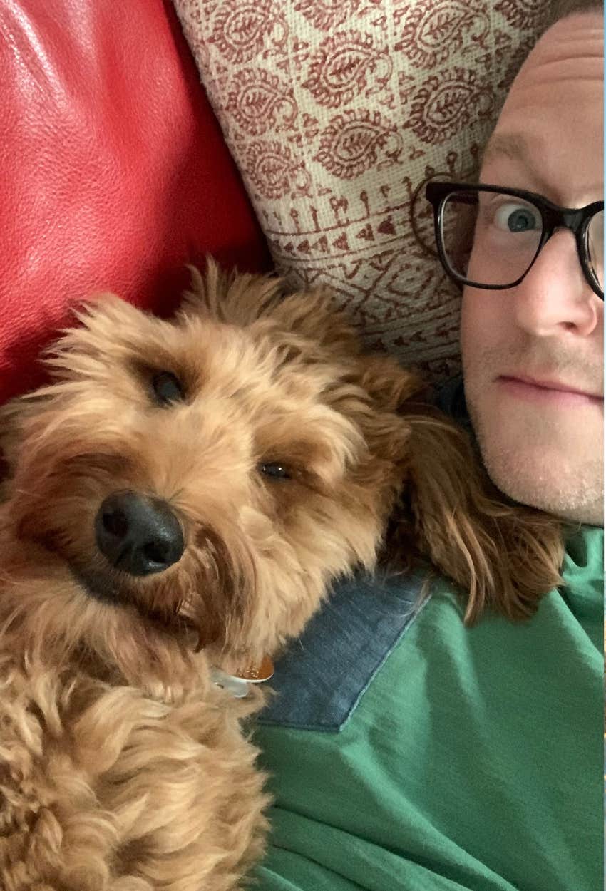 man with dog who likes hugs