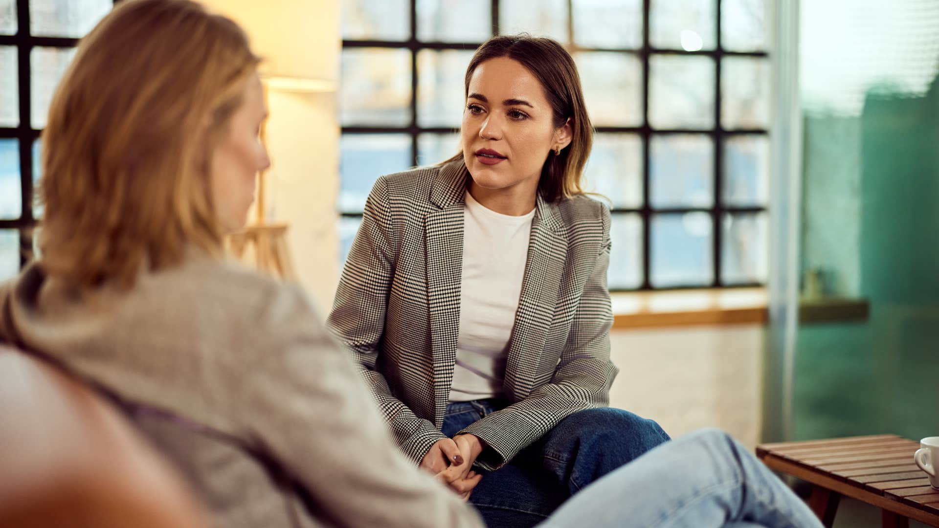 woman not celebrating her friends win during conversation