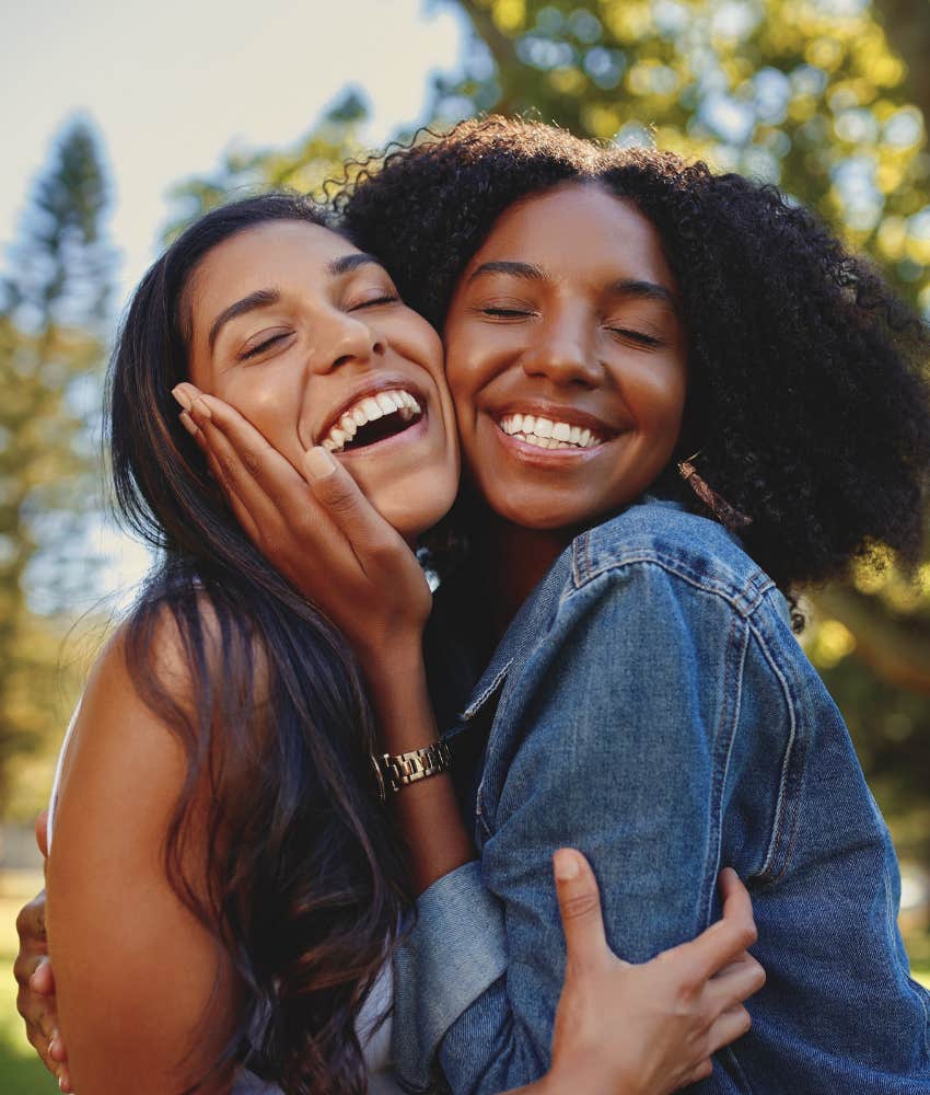 Two women hug.