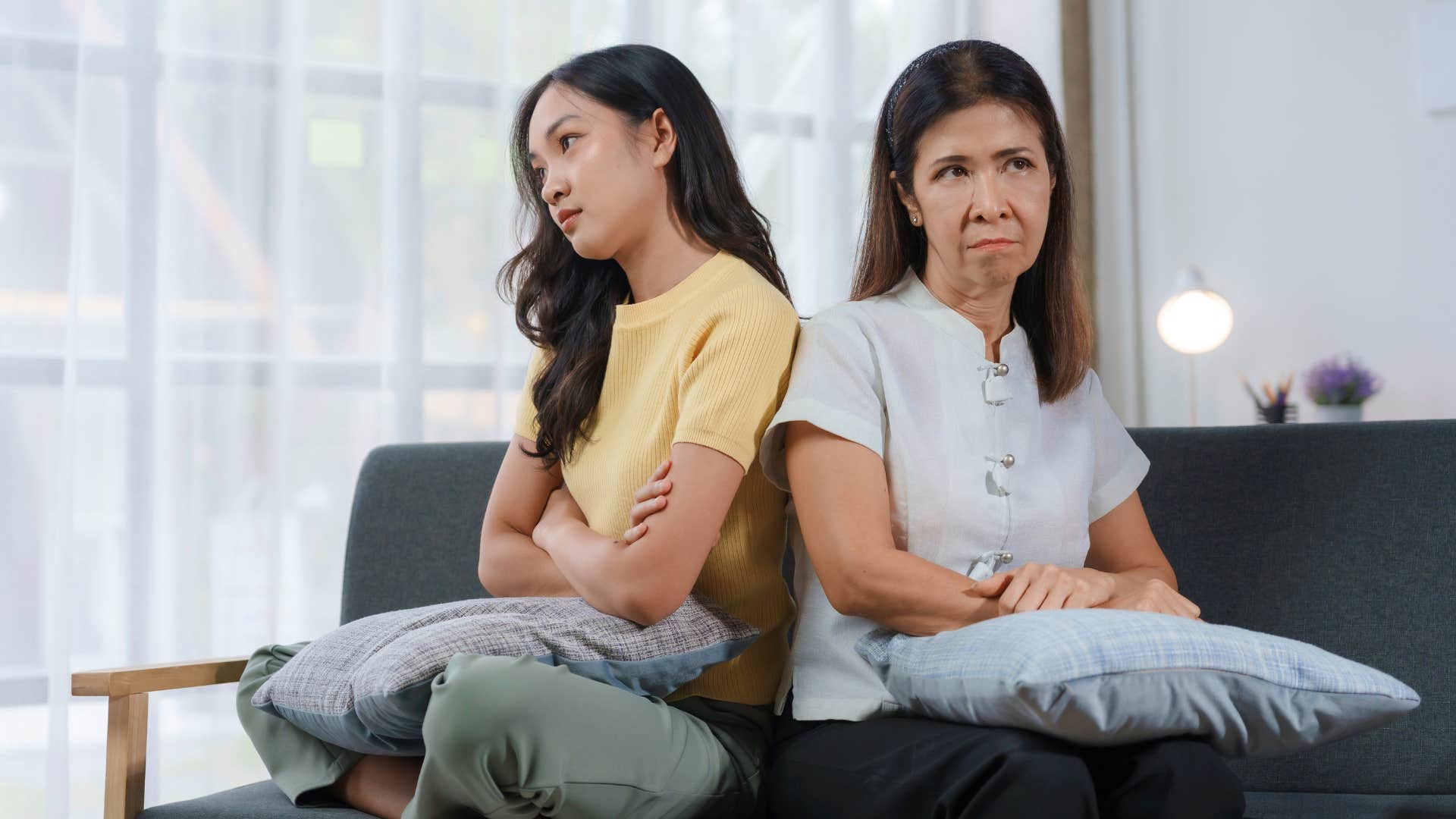 passive-aggressive mother and daughter turned away from each other