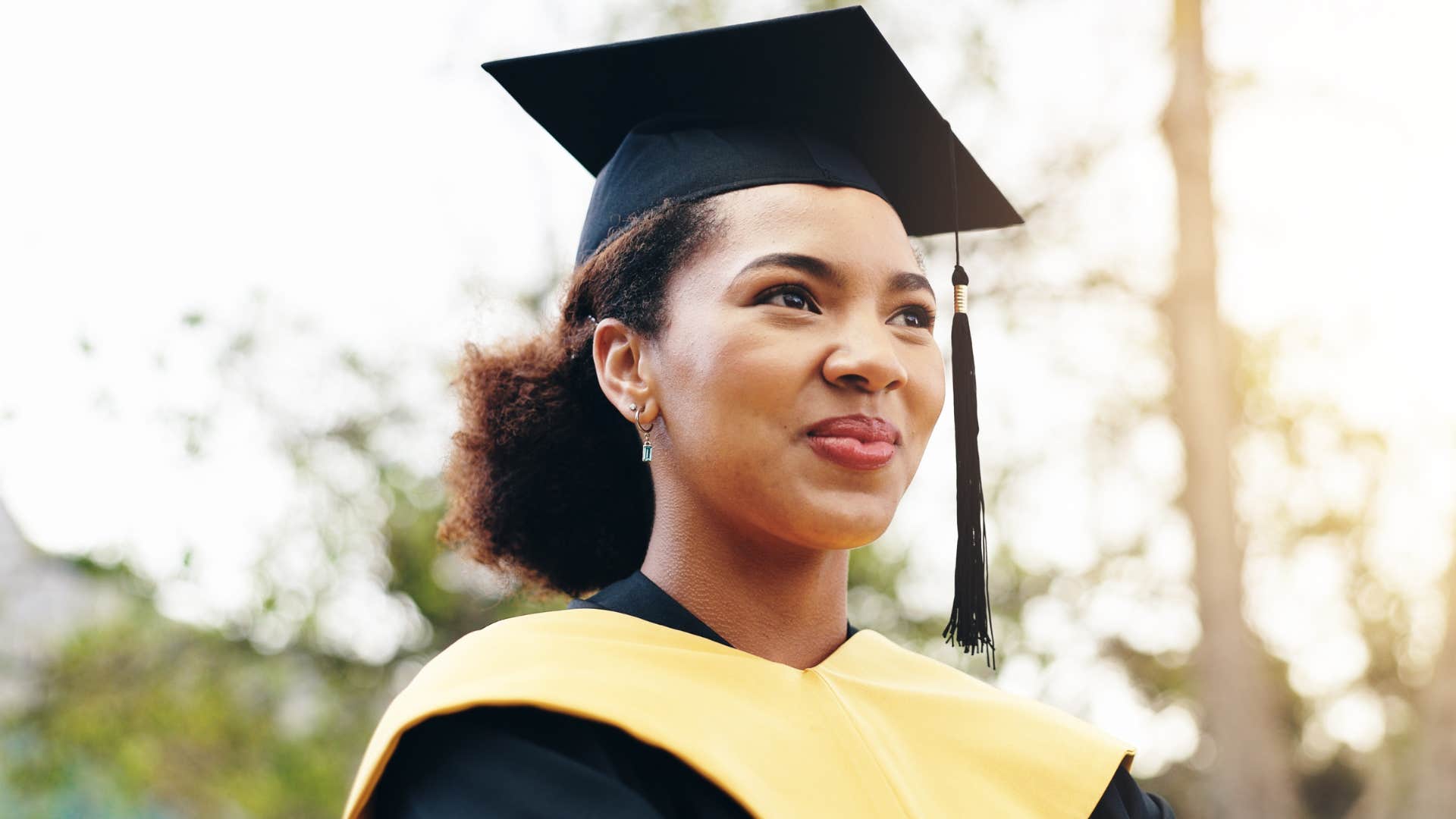 woman wearing a cap and gown for graduation