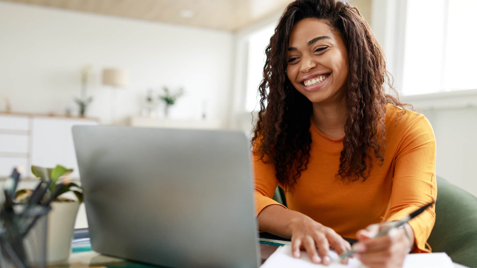 woman doing work for courses and programs on her laptop