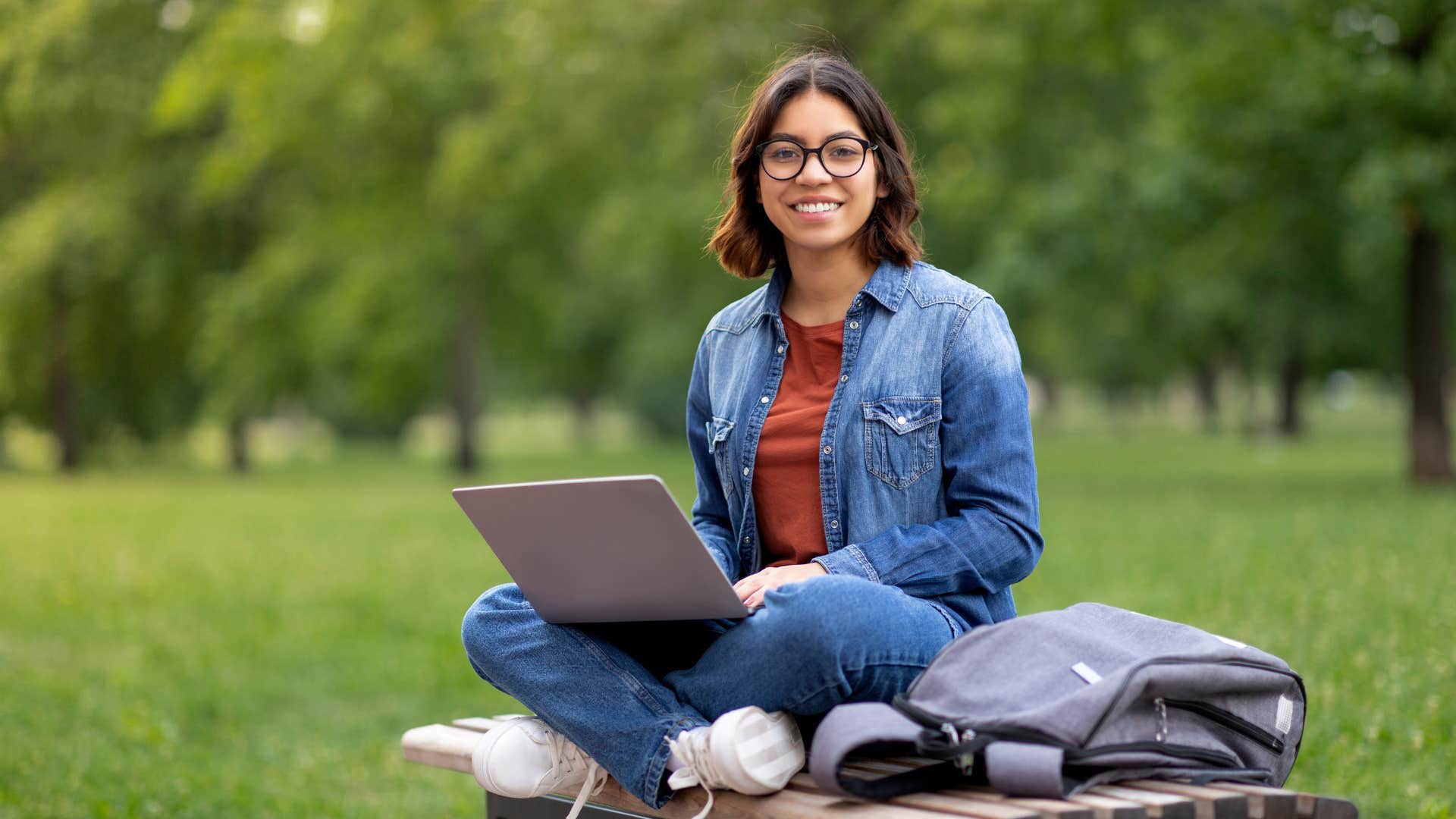 college student sitting in park