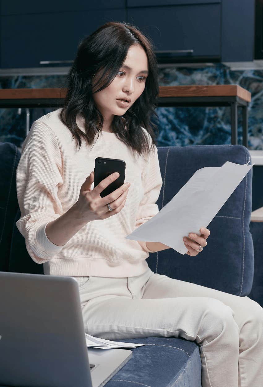 vulnerable gen-z woman staring shocked at finances