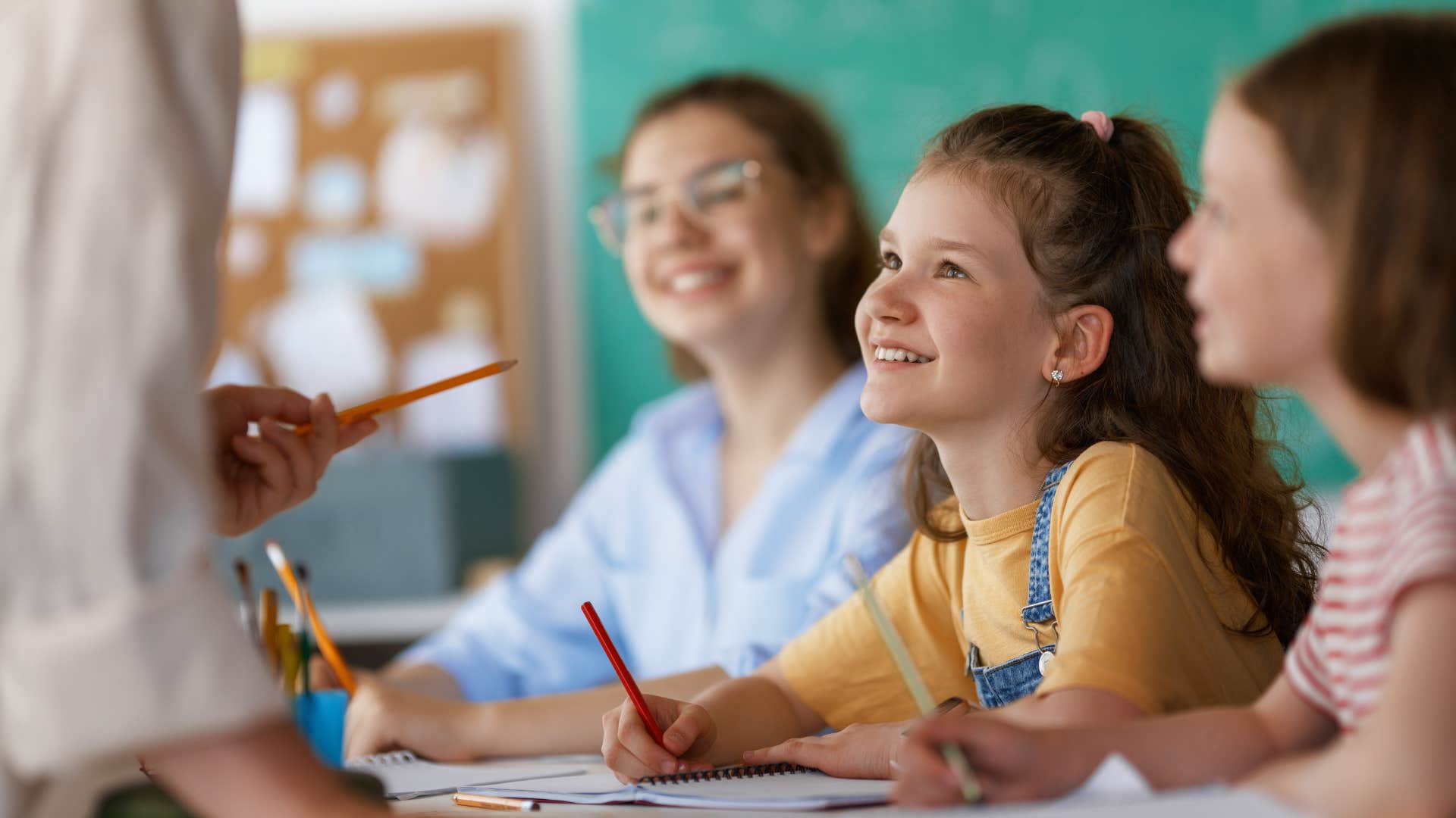 polite young girls who have manners in the classroom