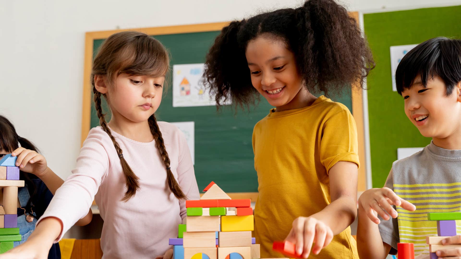little kids who respect each others differences playing together in a classroom
