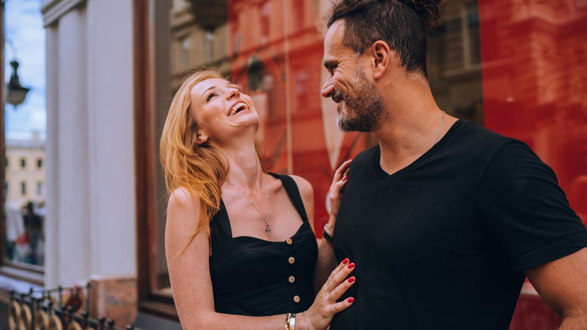 woman who is excellent at flirting complimenting a man's body