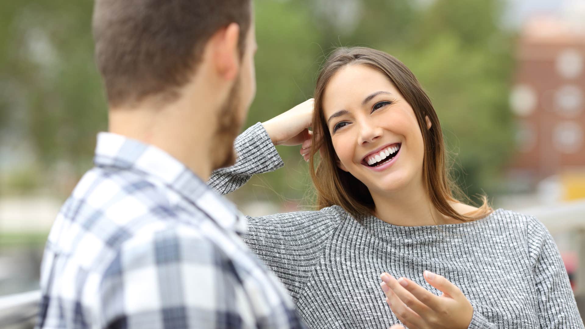man respectfully talking to happy woman