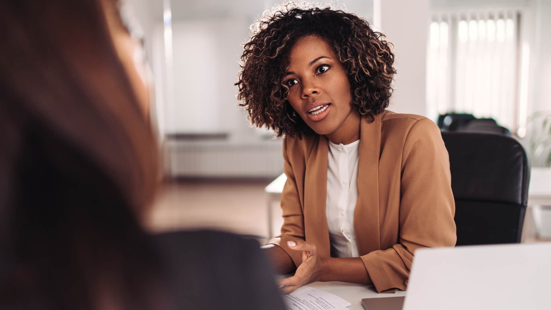 woman talking about gaslighting with a co-worker