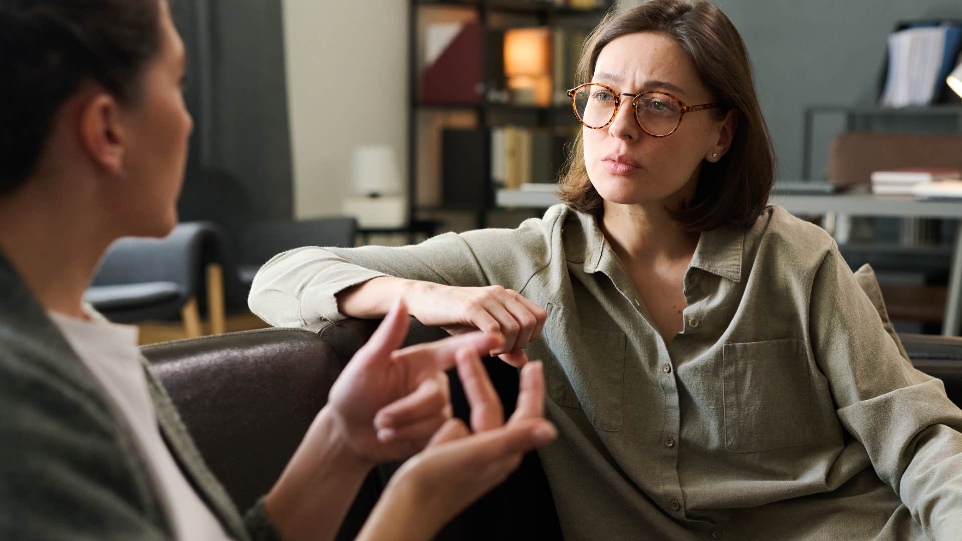 serious woman over-apologizing to her friend