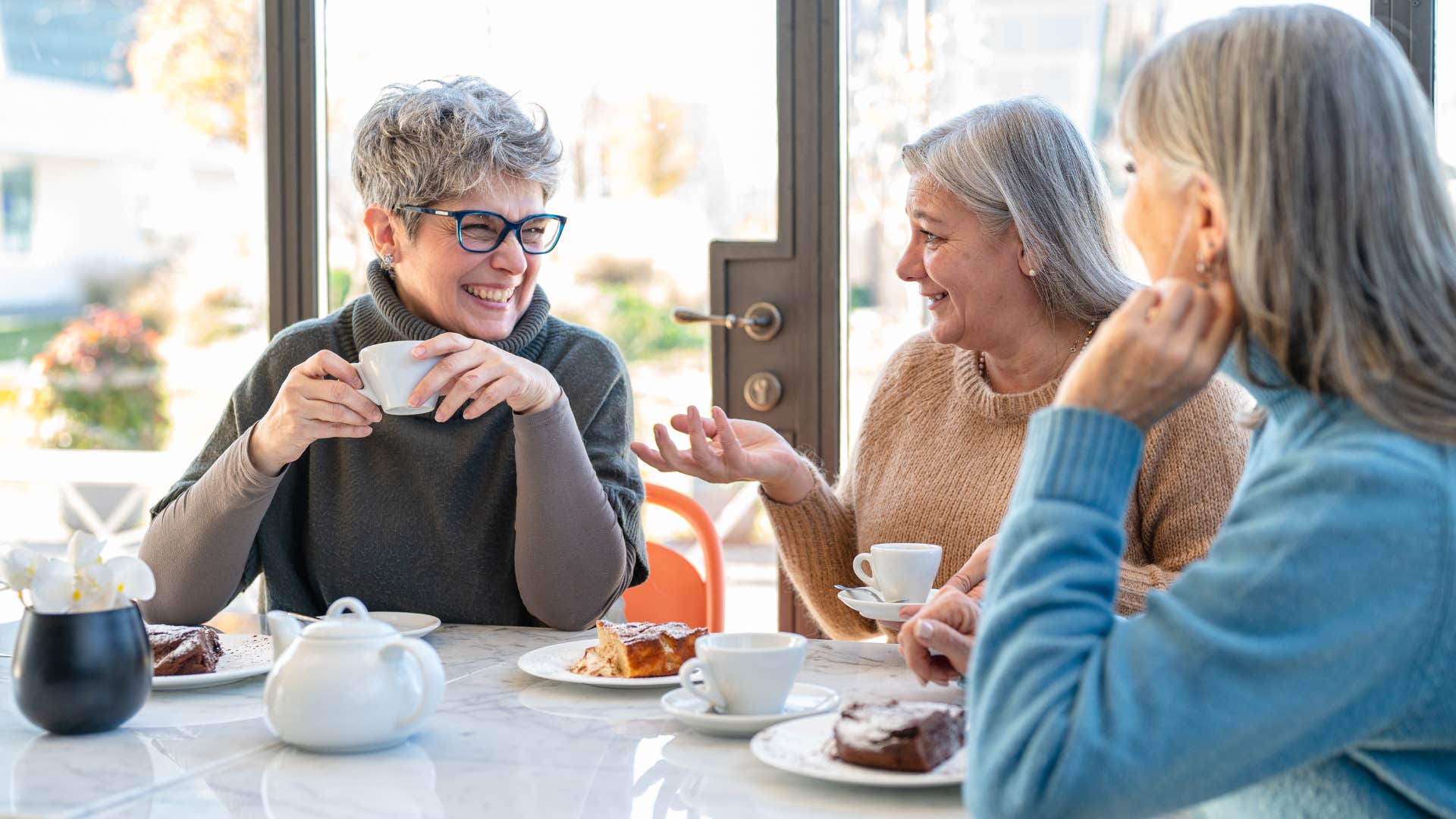 older women unafraid of judgment having conversation at lunch