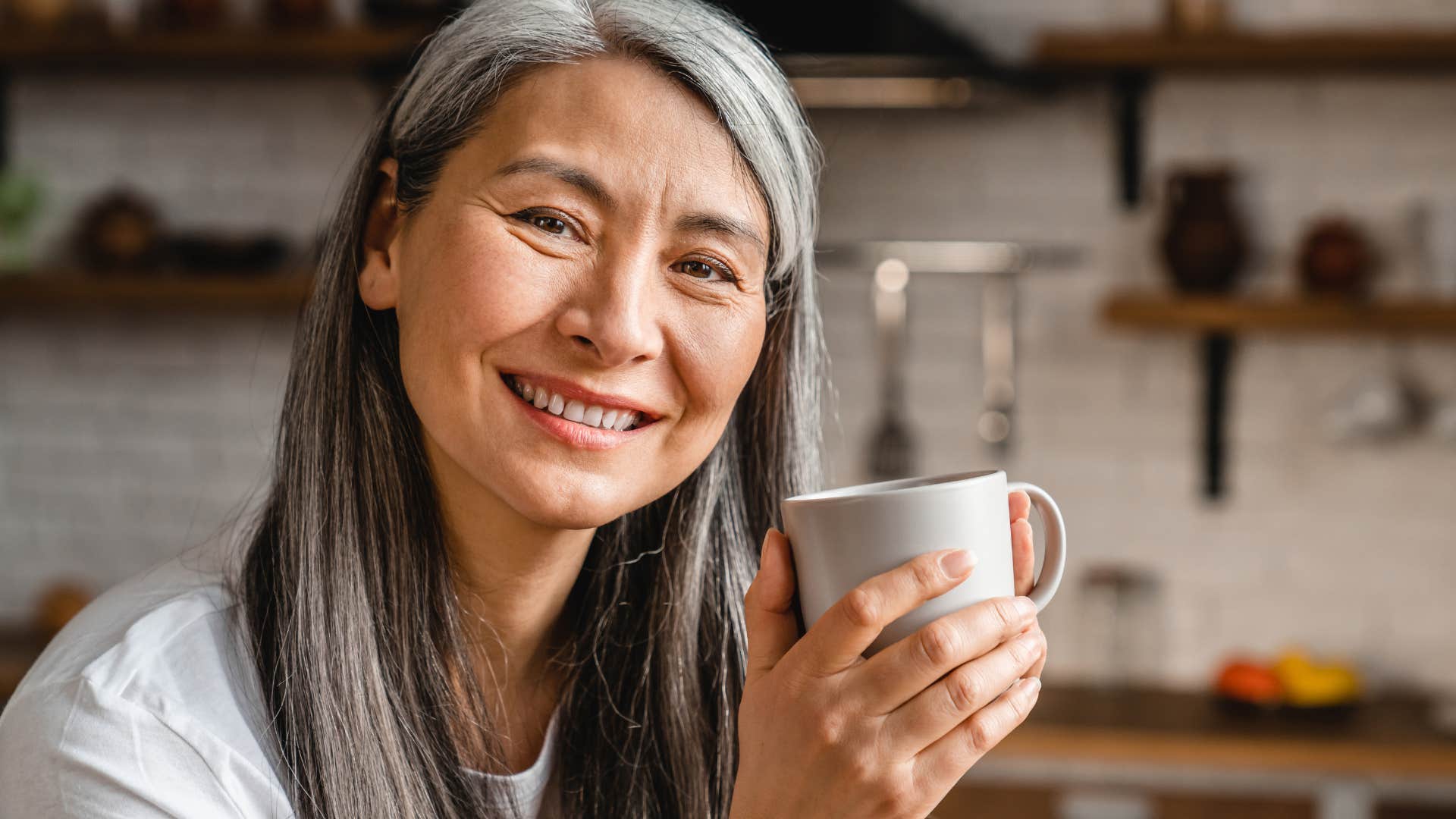 confident woman drinking coffee and smiling
