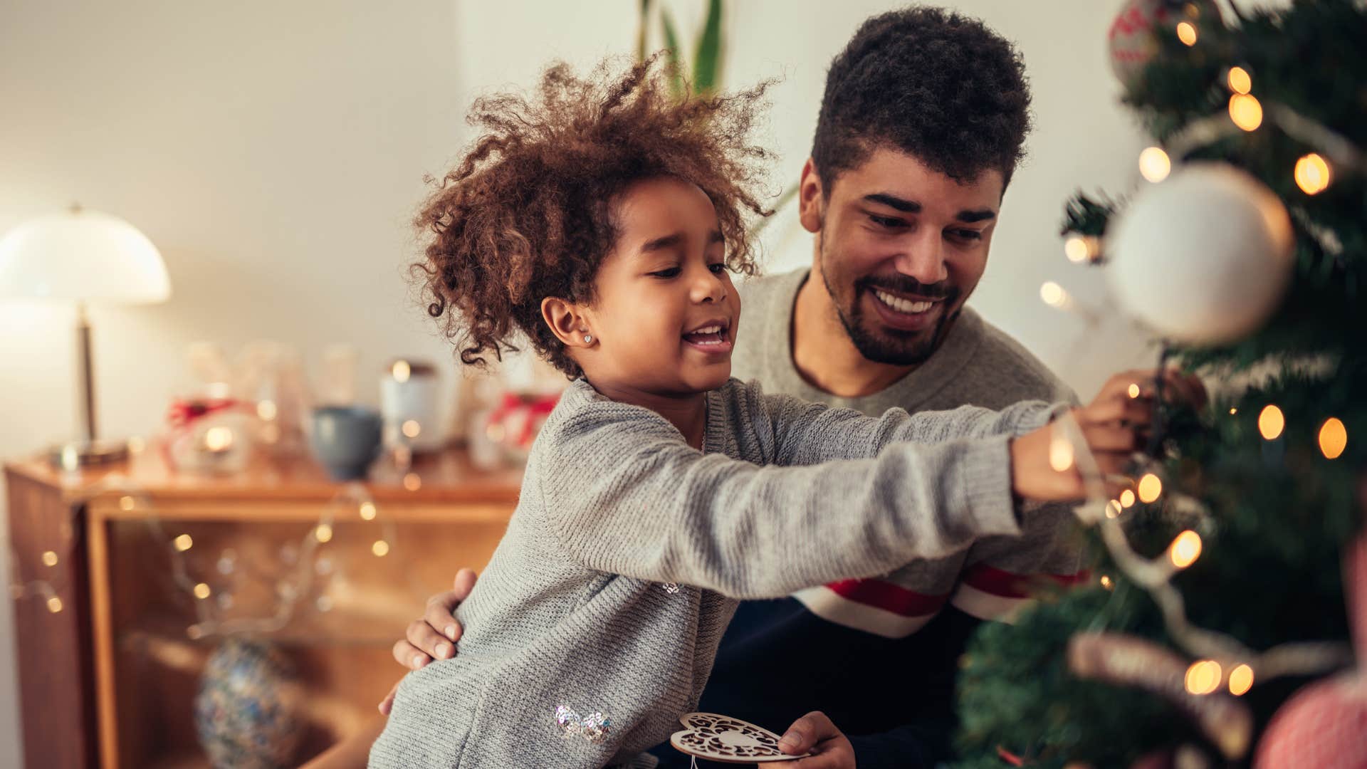 a man celebrates the holidays with his daughter passing down traditions