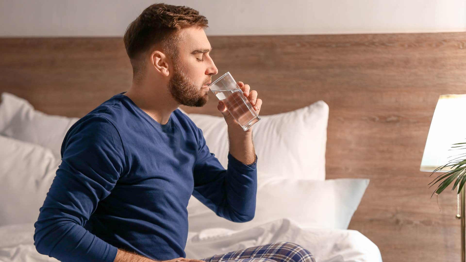 a man drinks water early in the morning