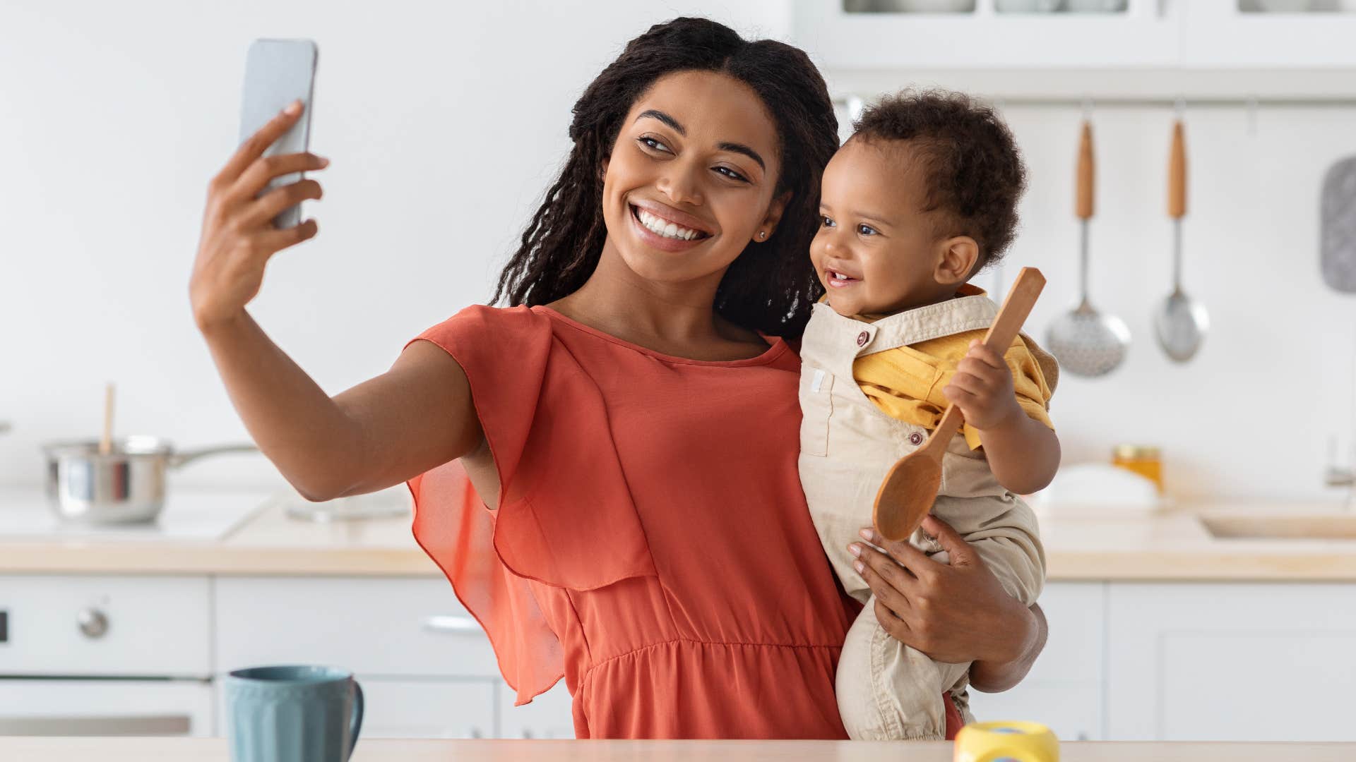 a woman poses for a photo with her baby