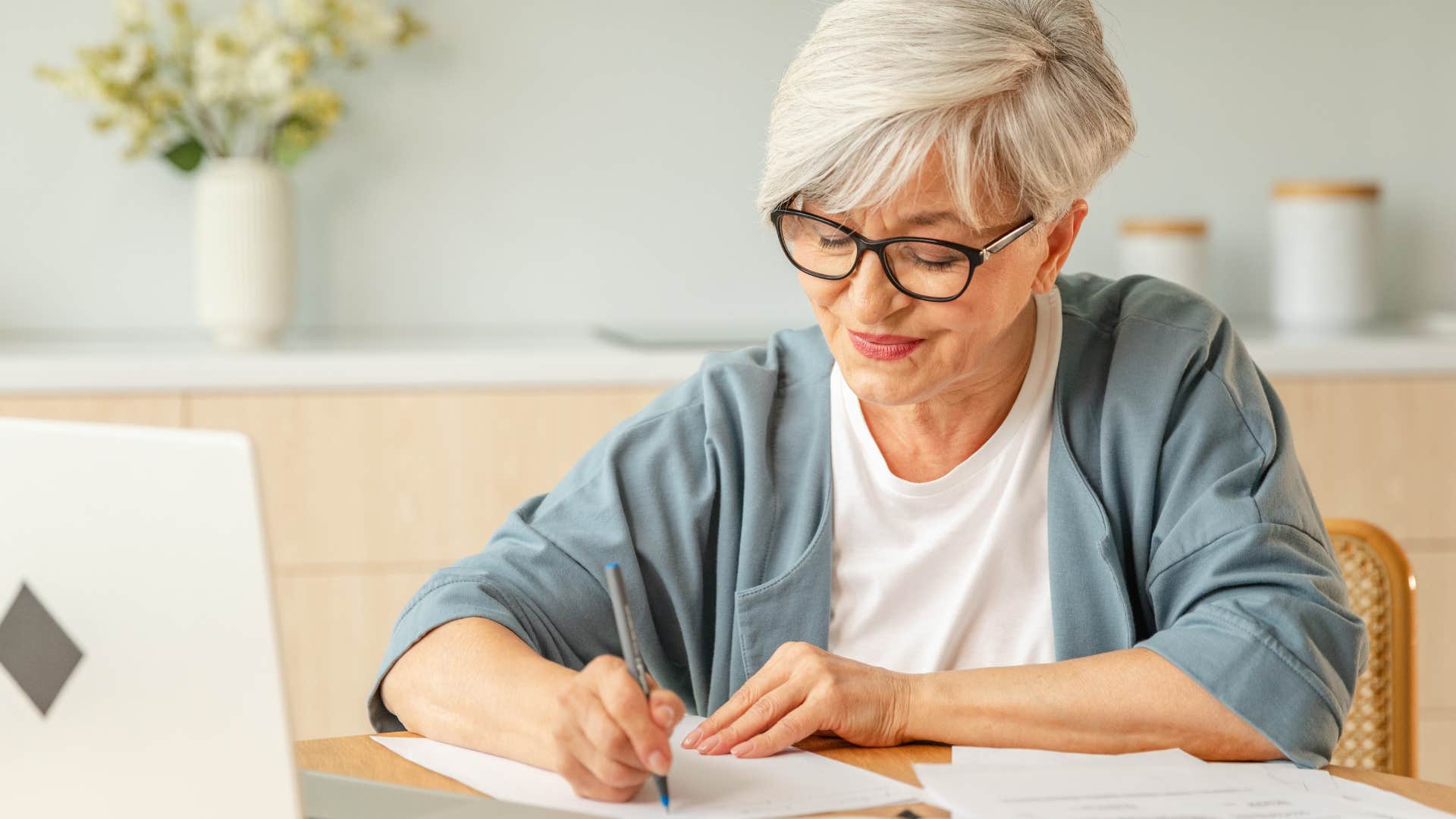 an elderly woman likes writing everything down by hand