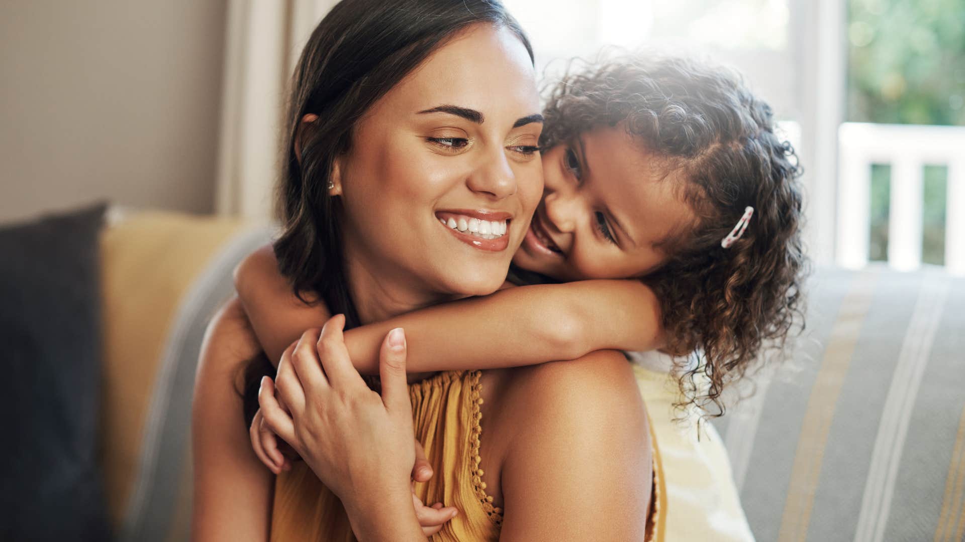 girl giving her mom a warm hug