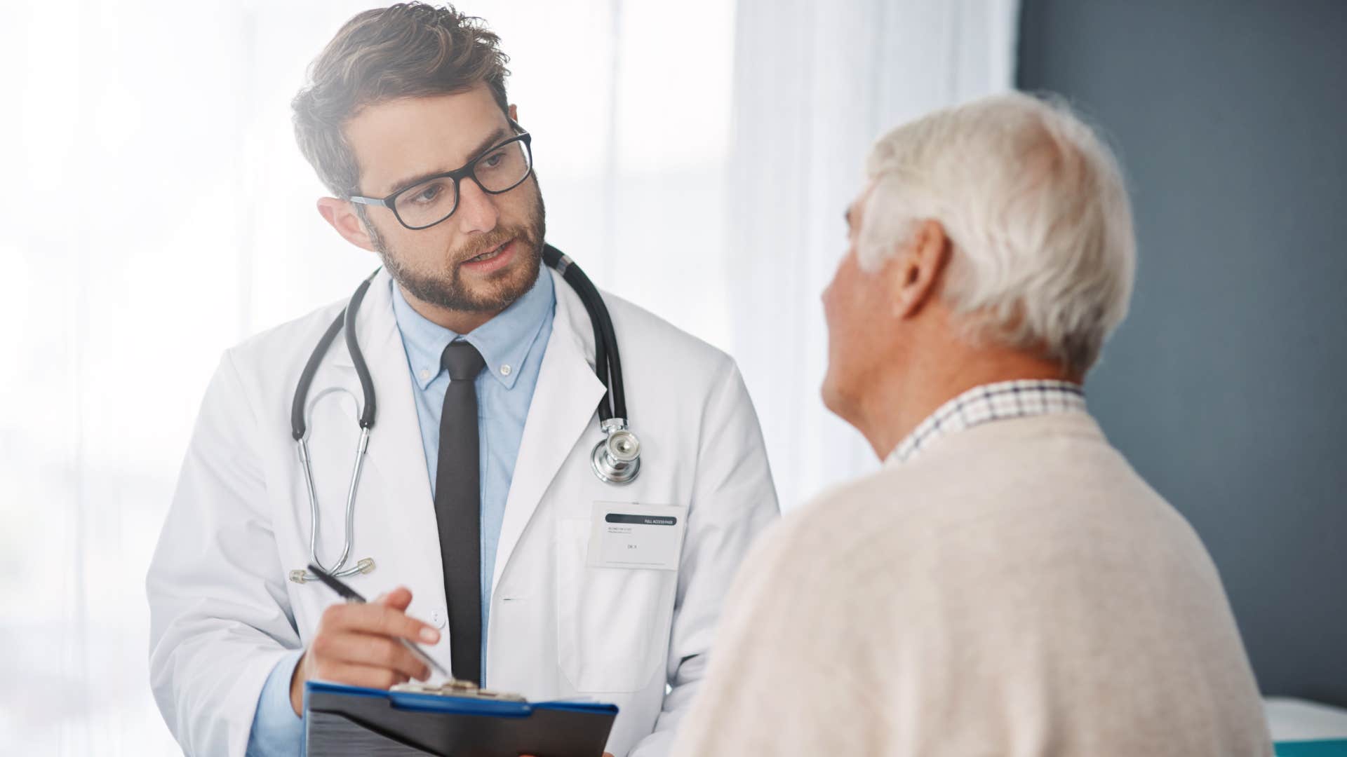 Man with access to medical care talking to a doctor.
