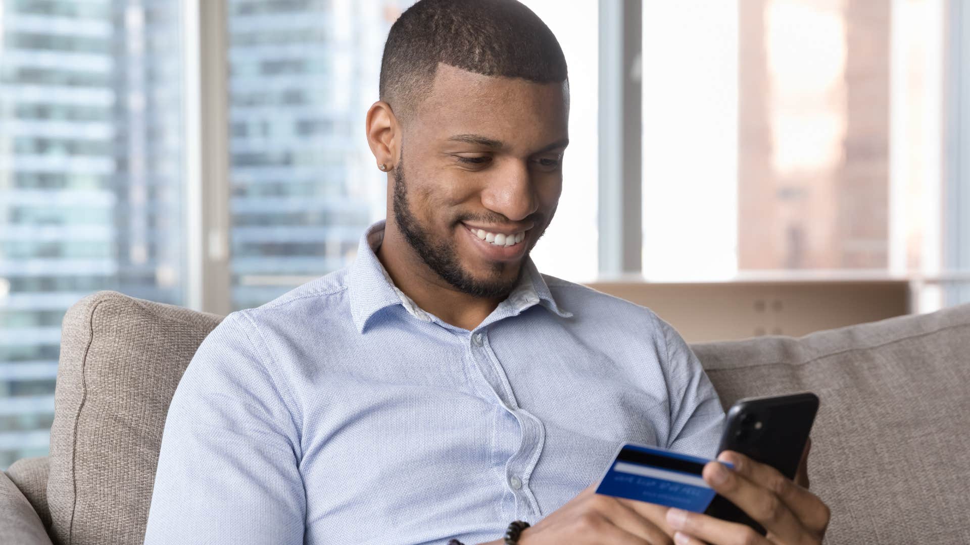 Man smiling and feeling confident about paying bills.