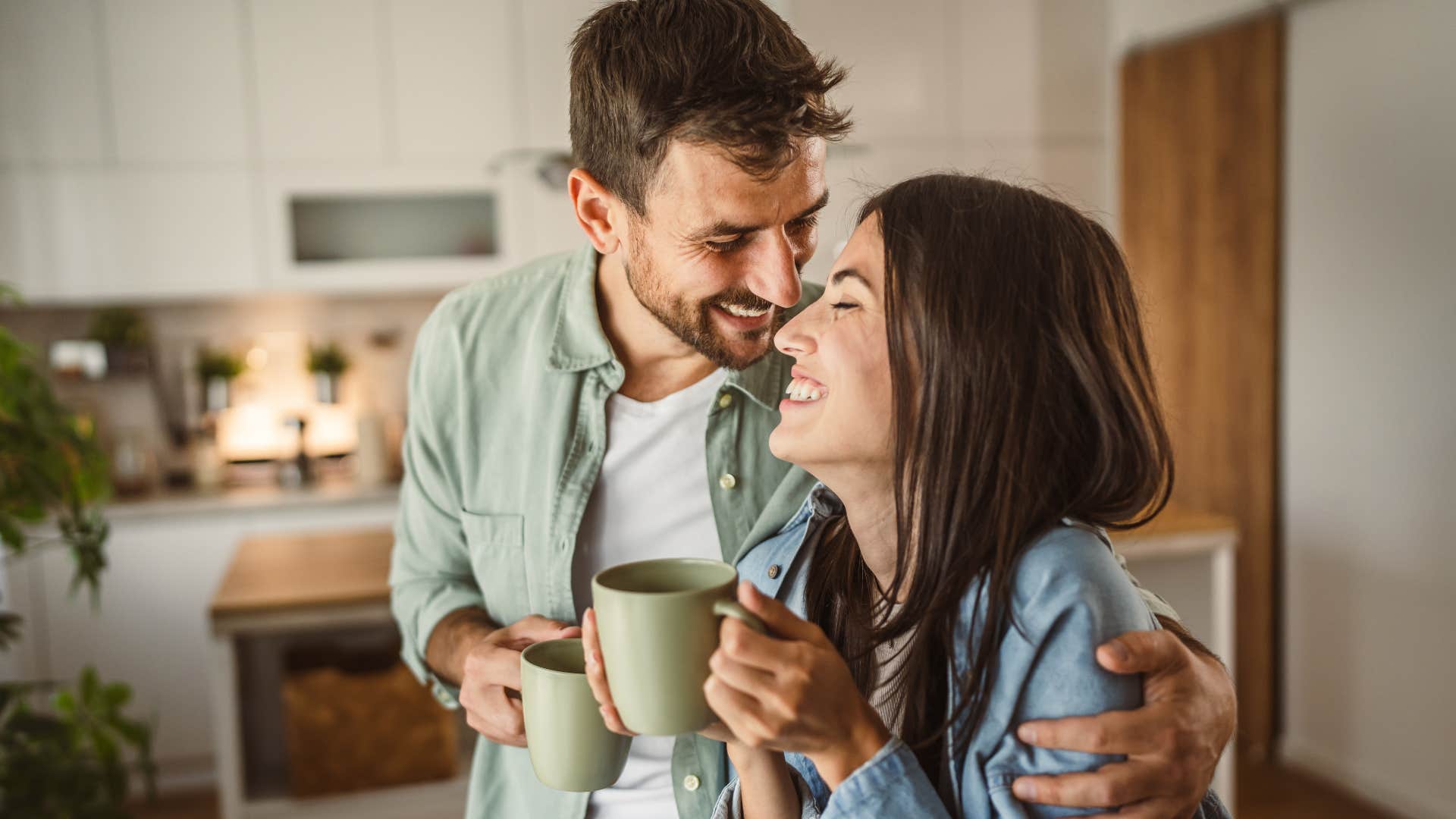 Couple smiling and laughing together at home.