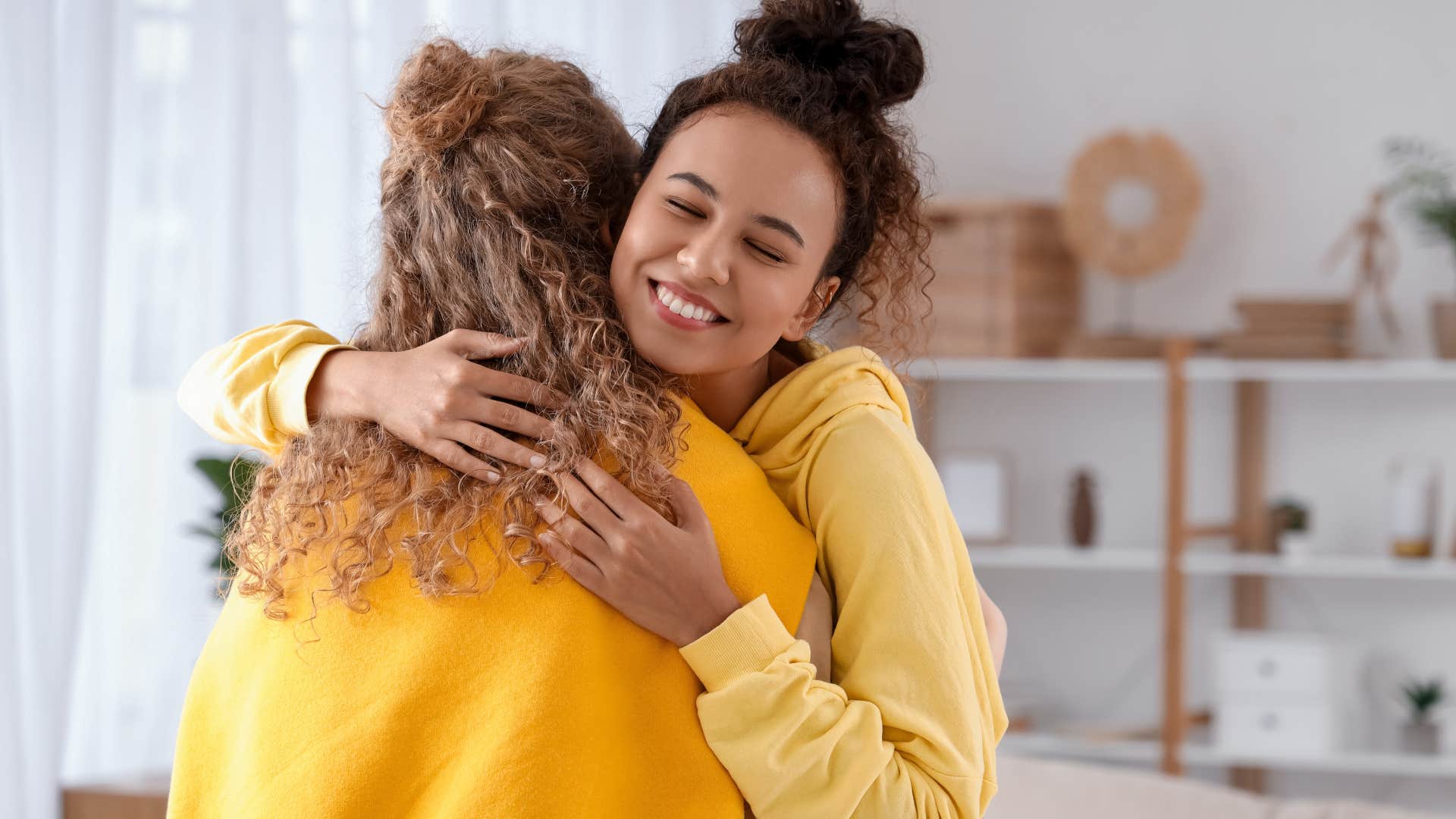 Woman seeking support while hugging a friend.