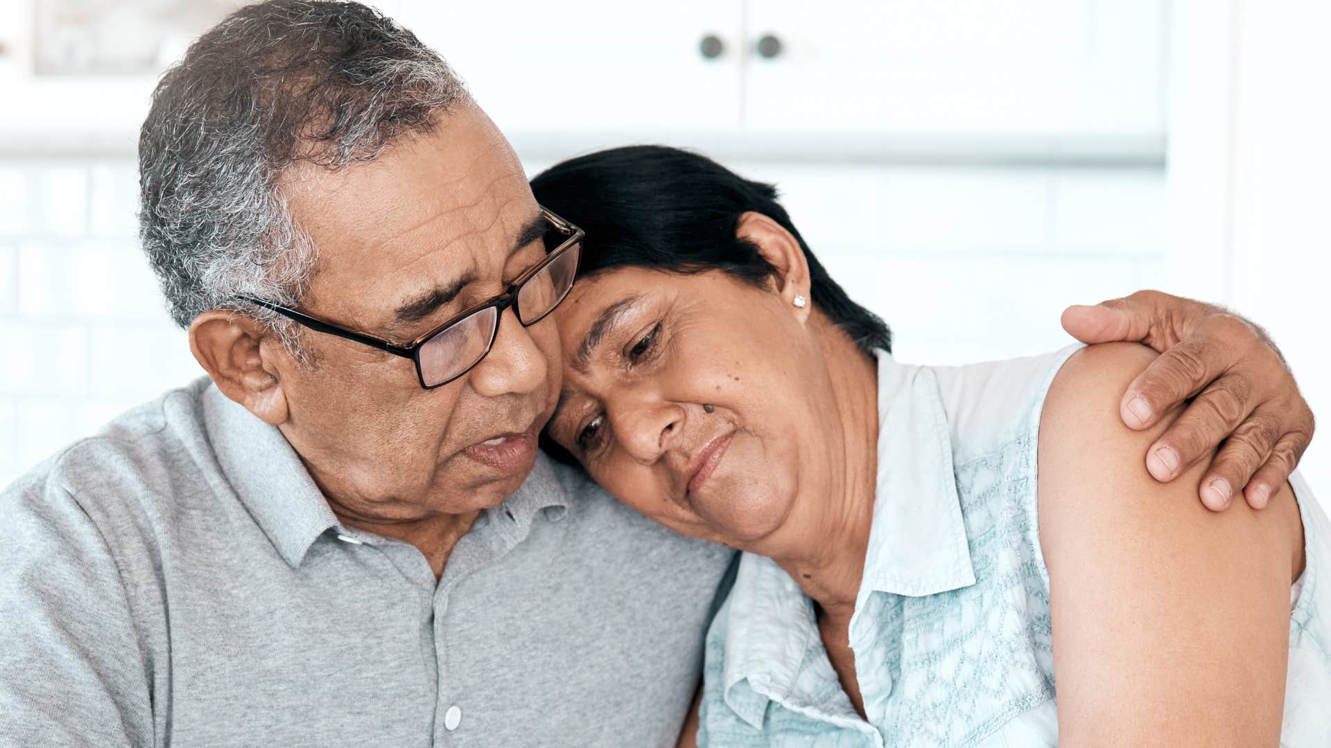 man apologizing to his wife at home