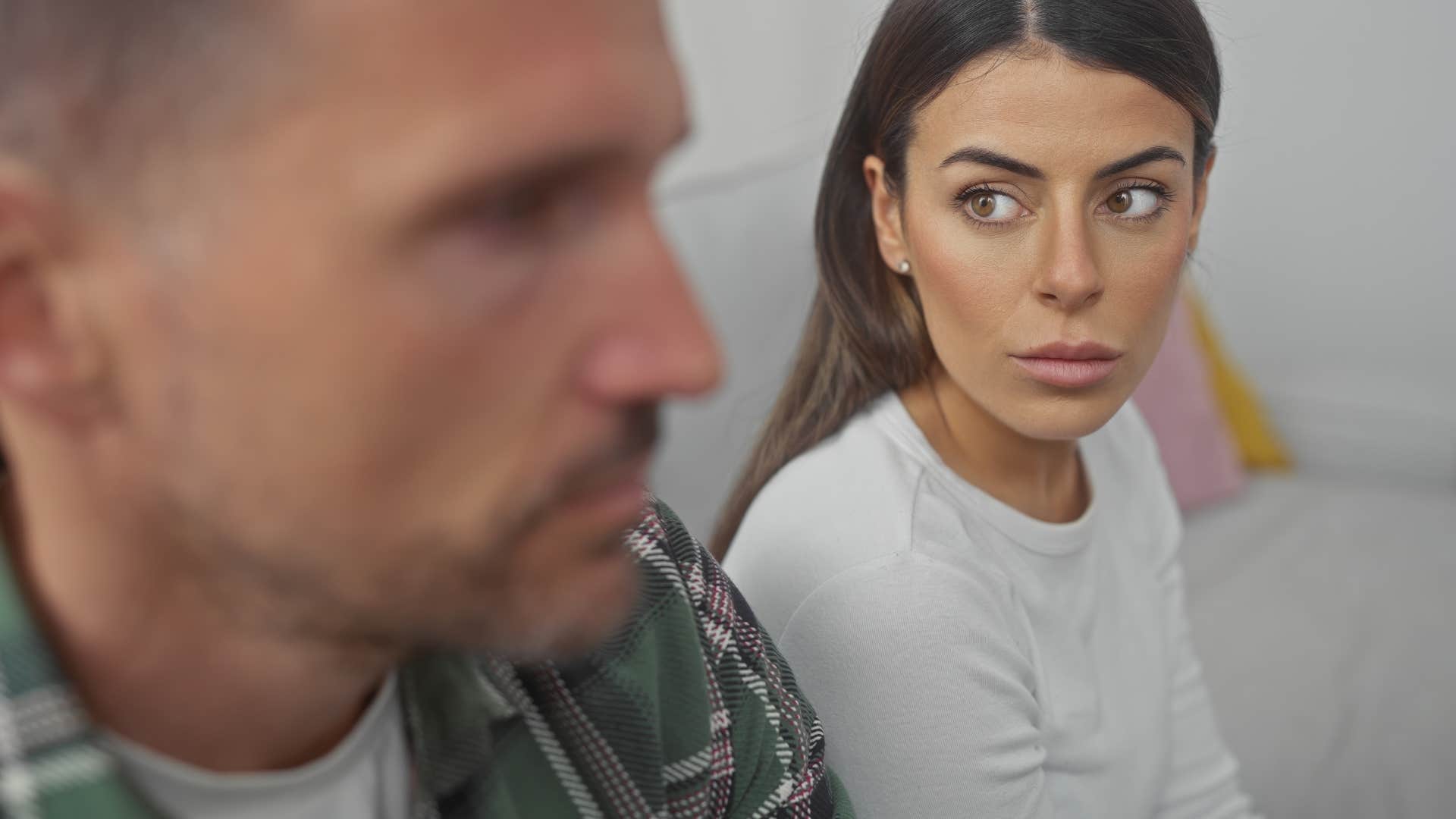 couple disagreeing on their couch