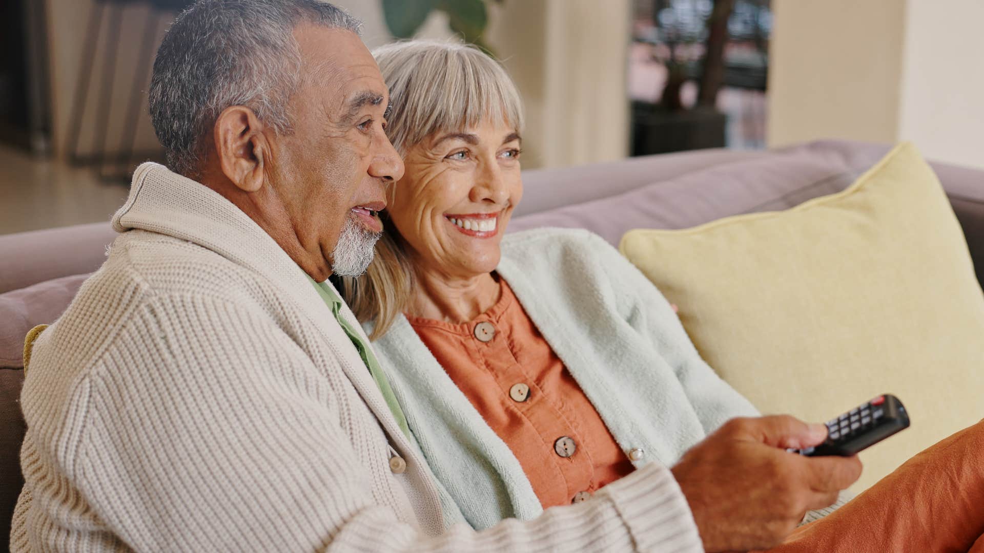 happy couple doing nothing together sitting on their couch