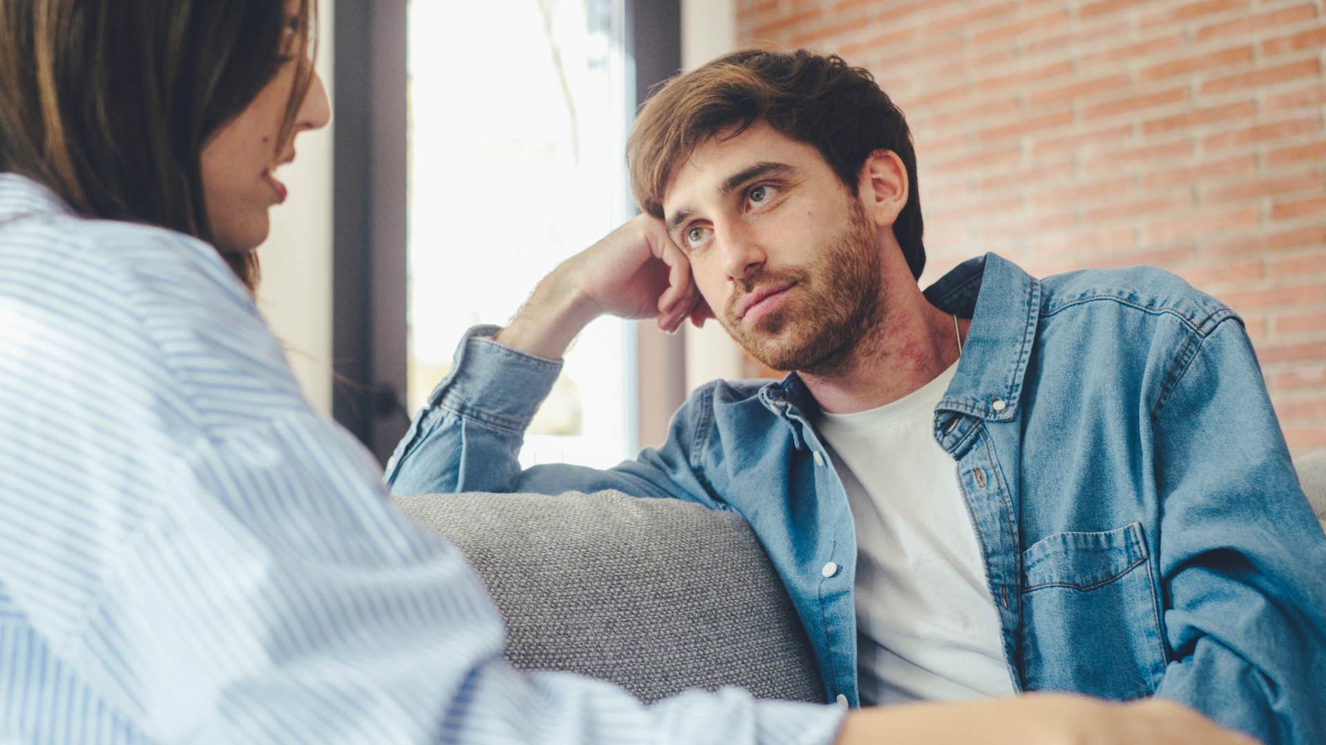 couple having hard conversations on their couch together