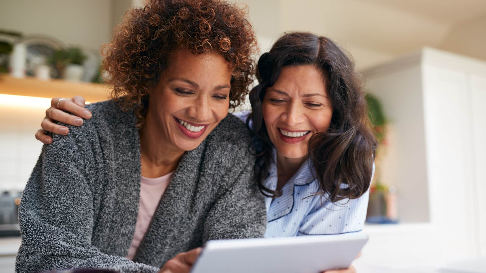 couple smiling and making decisions together at home
