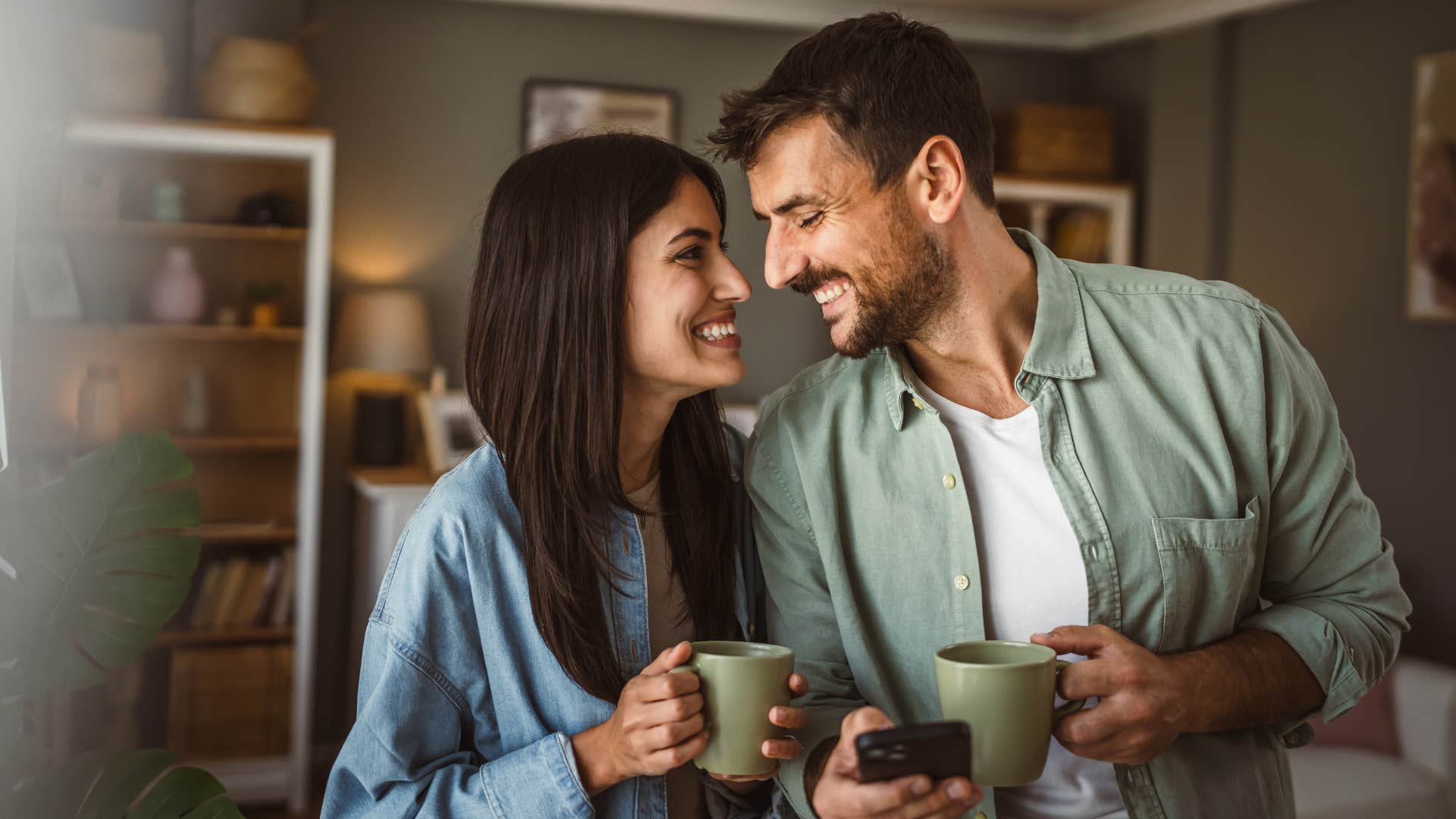 happy couple sharing responsibilities smiling drinking coffee together